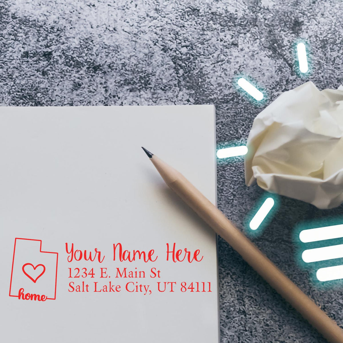 Custom rubber stamp design with name and address on a blank envelope, featuring a home icon, pencil, and crumpled paper.