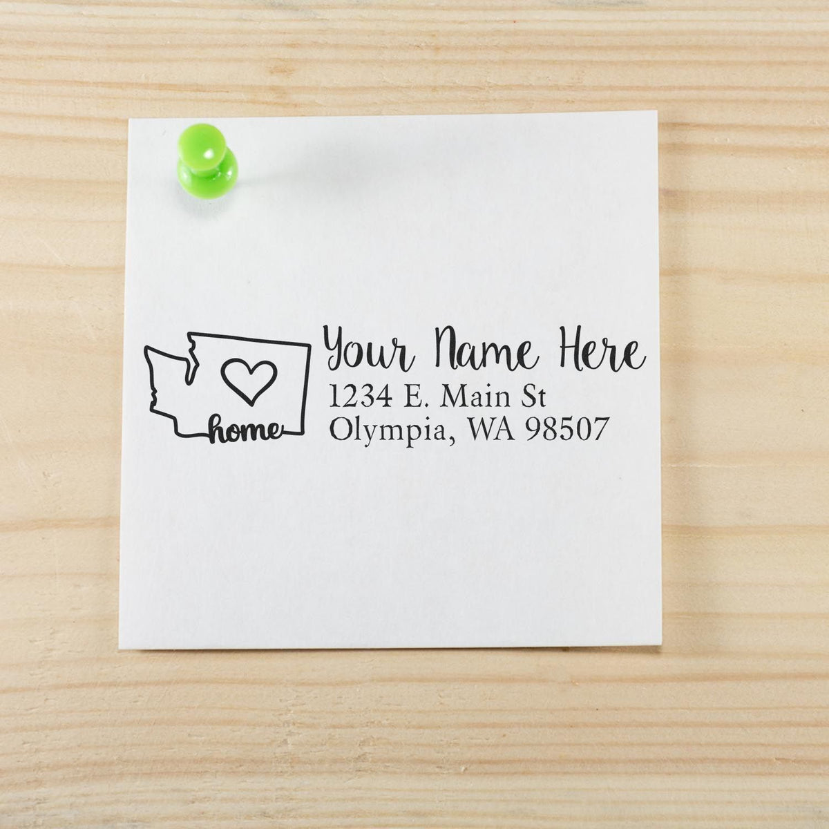 Custom rubber address stamp with Washington home design, personalized name, and return address on white paper.