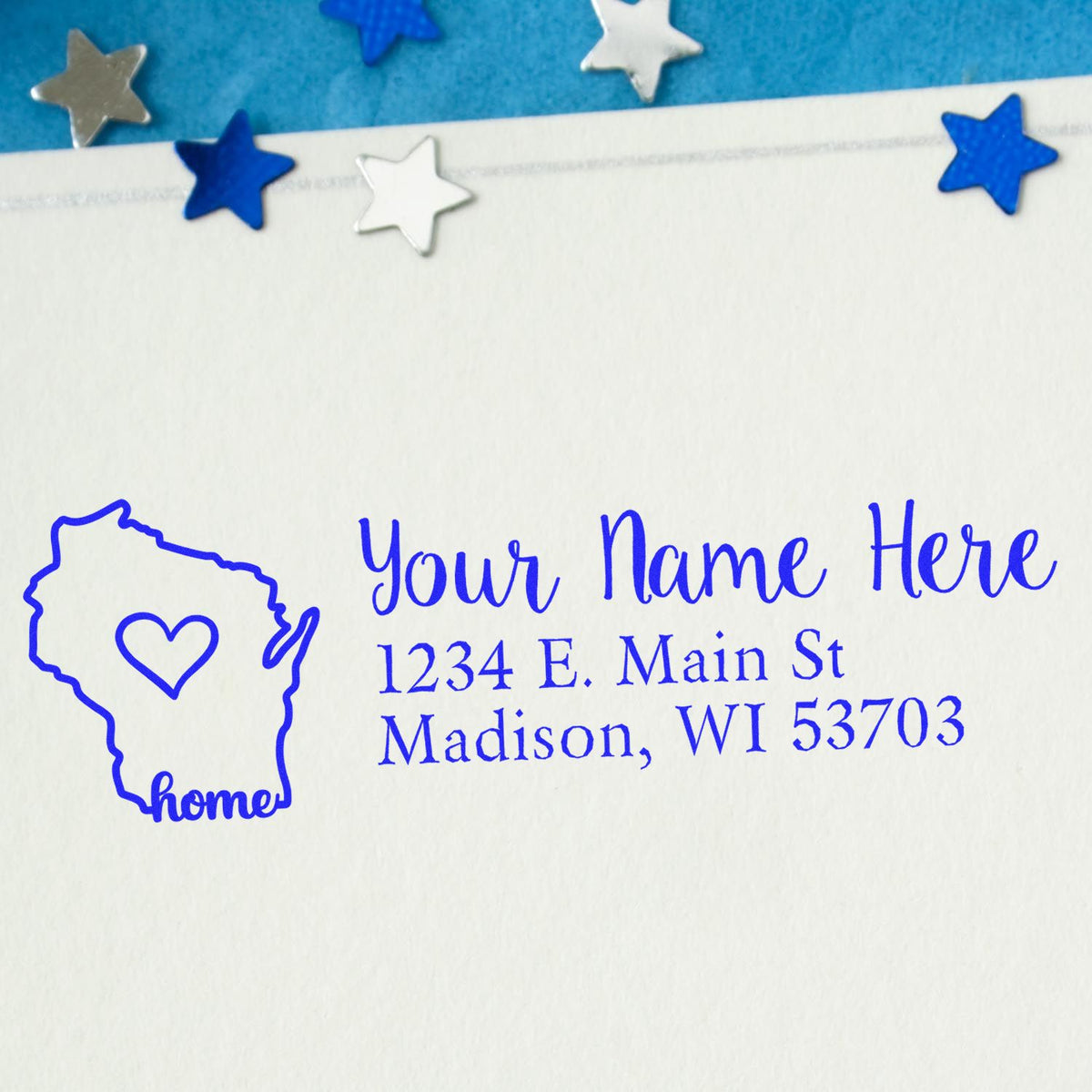 Custom return address rubber stamp featuring a Wisconsin home outline, heart, and personalized name and address in blue ink.