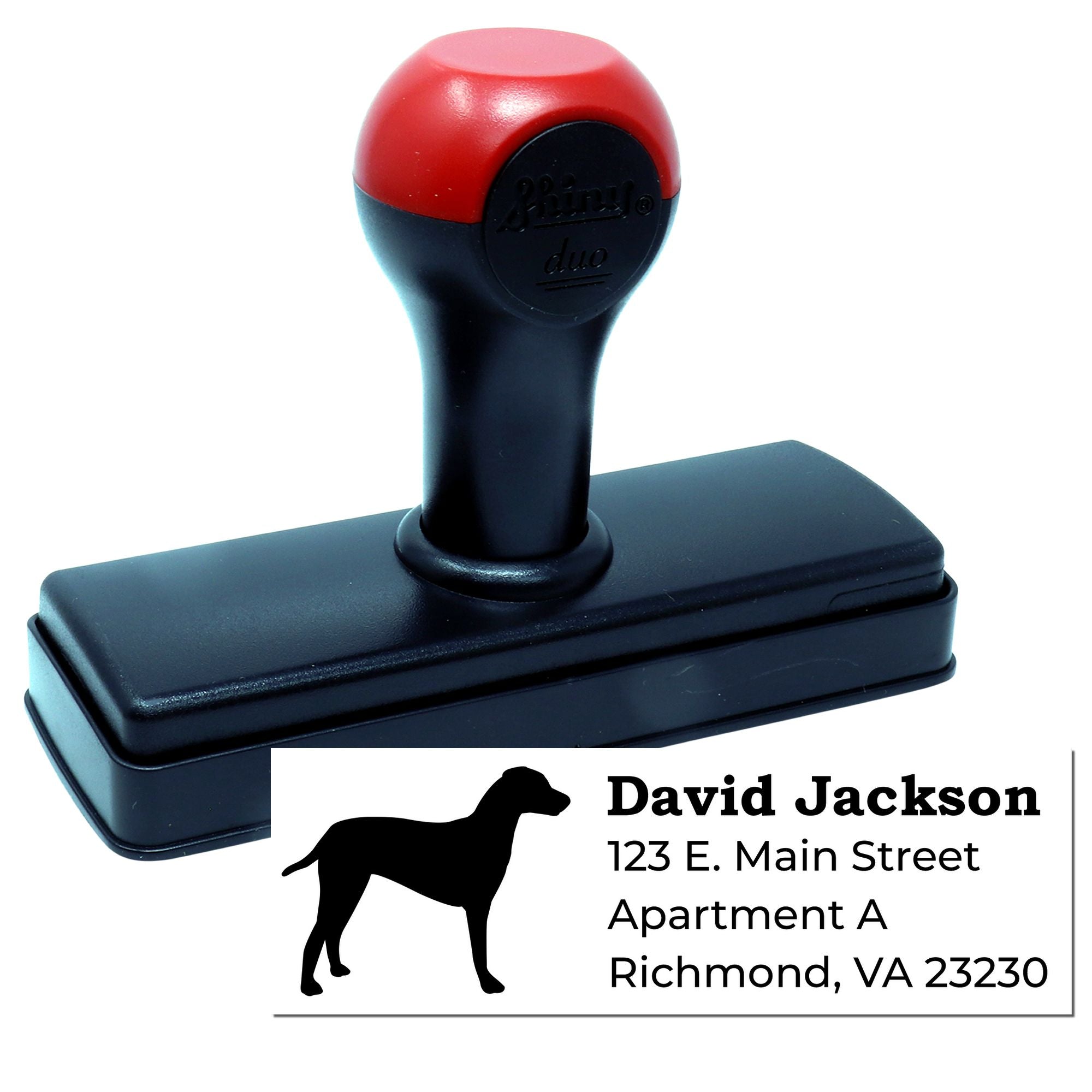 Custom self-inking rubber address stamp with dog silhouette, showing personalized return address imprint.