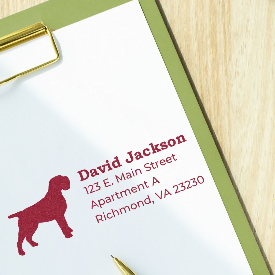 Personalized rubber return address stamp with dog silhouette, name, and Richmond, VA address on clipboard paper.