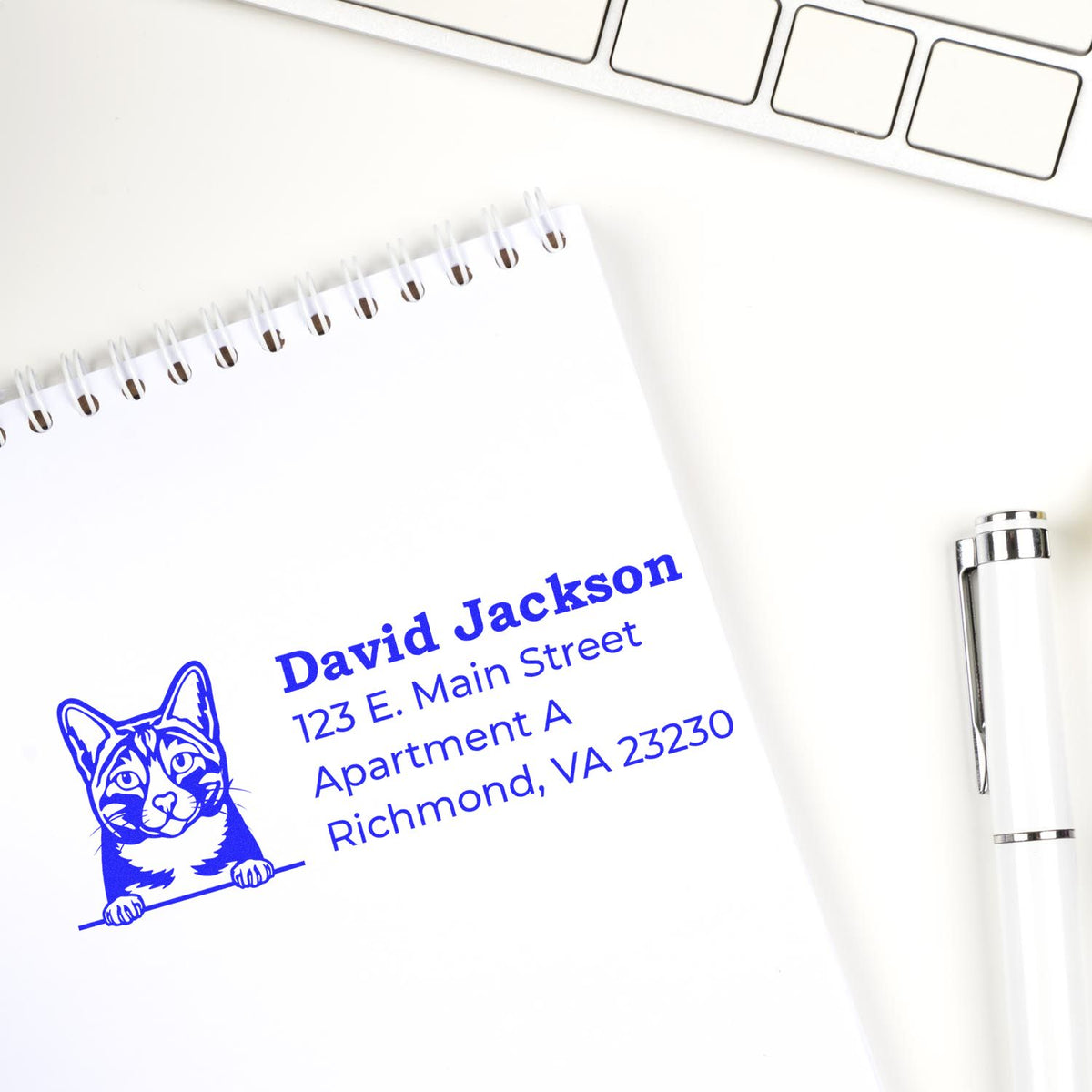 Custom cat address rubber stamp on notepad with return address, ideal for personalized mailing and office use.