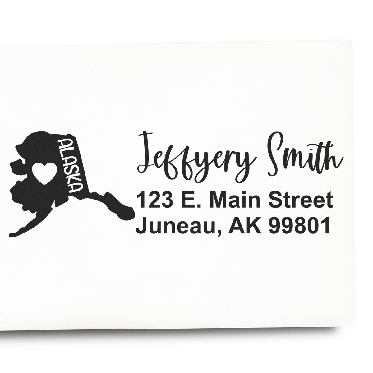 Custom Alaska return address rubber stamp with state silhouette, name, and Juneau, AK mailing address.