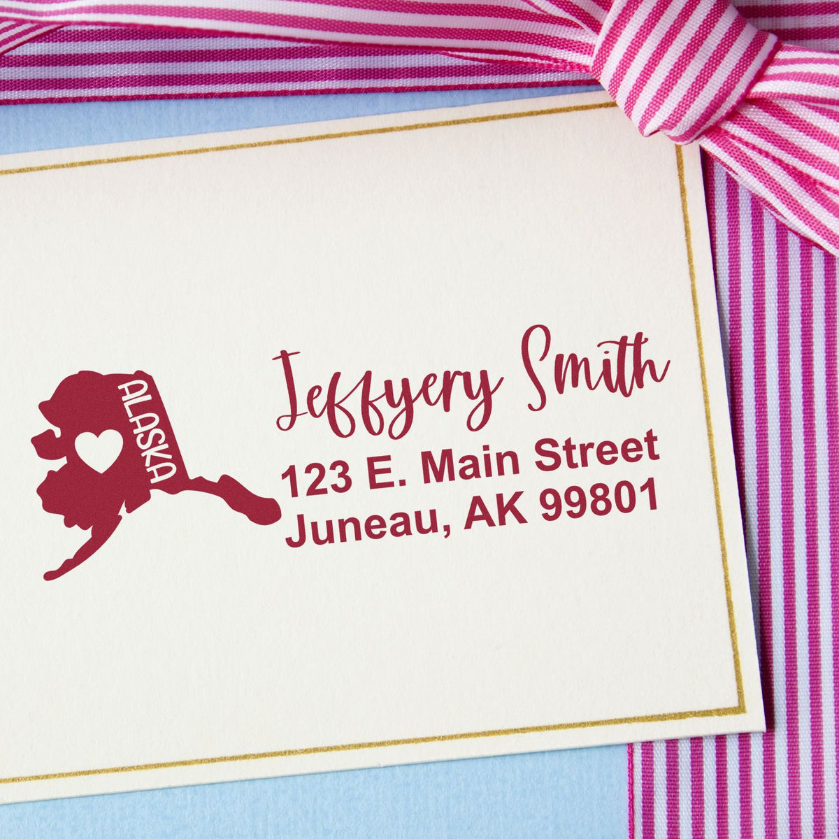 Custom Alaska return address rubber stamp with name and mailing address on elegant stationery card.