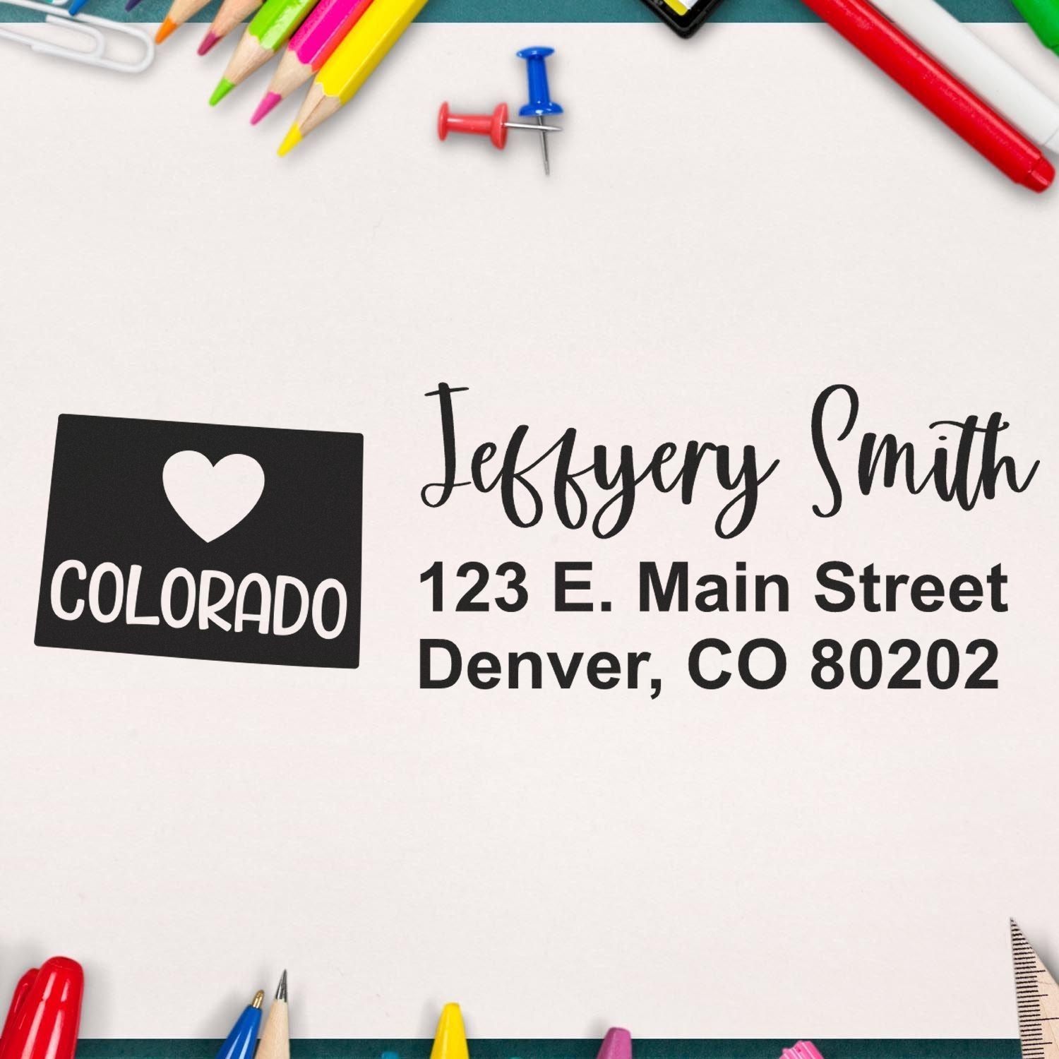 Custom rubber stamp for return mail with Colorado heart logo, name, and Denver address.