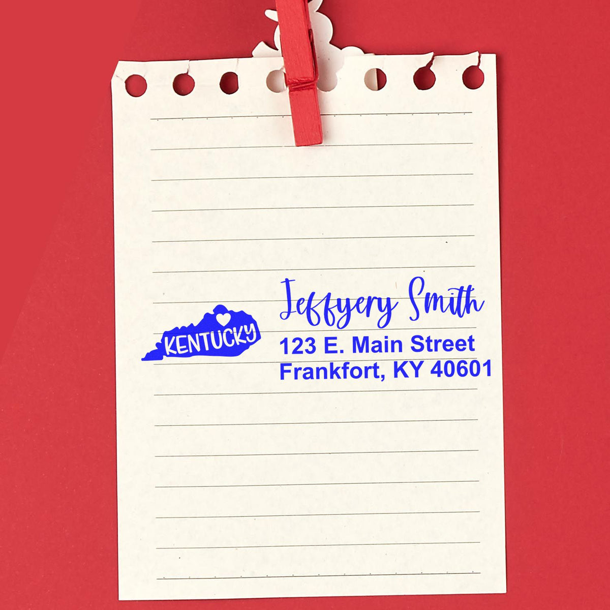 Personalized Kentucky return address rubber stamp impression on a notepad, featuring name and street address.