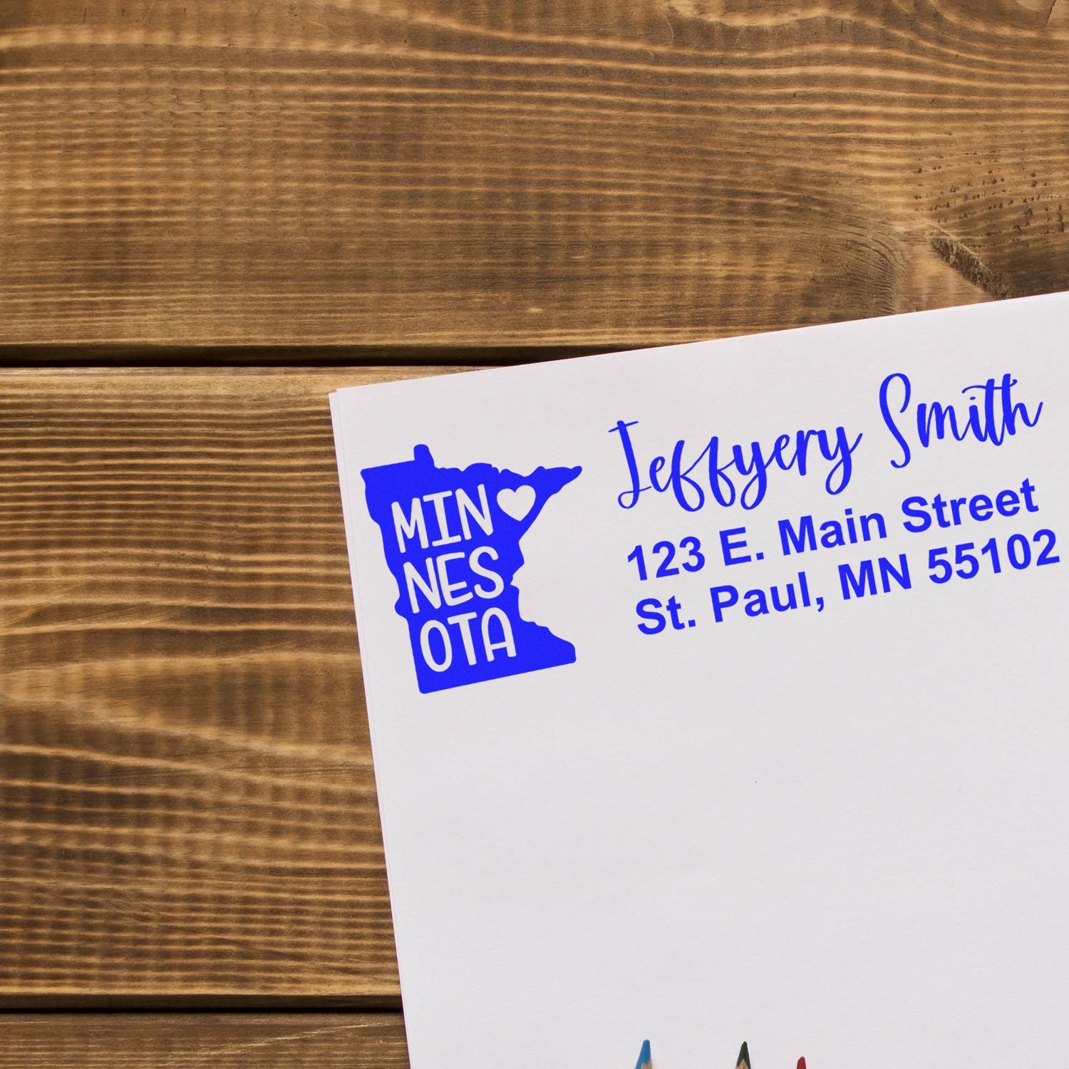 Custom Minnesota return address rubber stamp on envelope with name and St. Paul, MN mailing details.