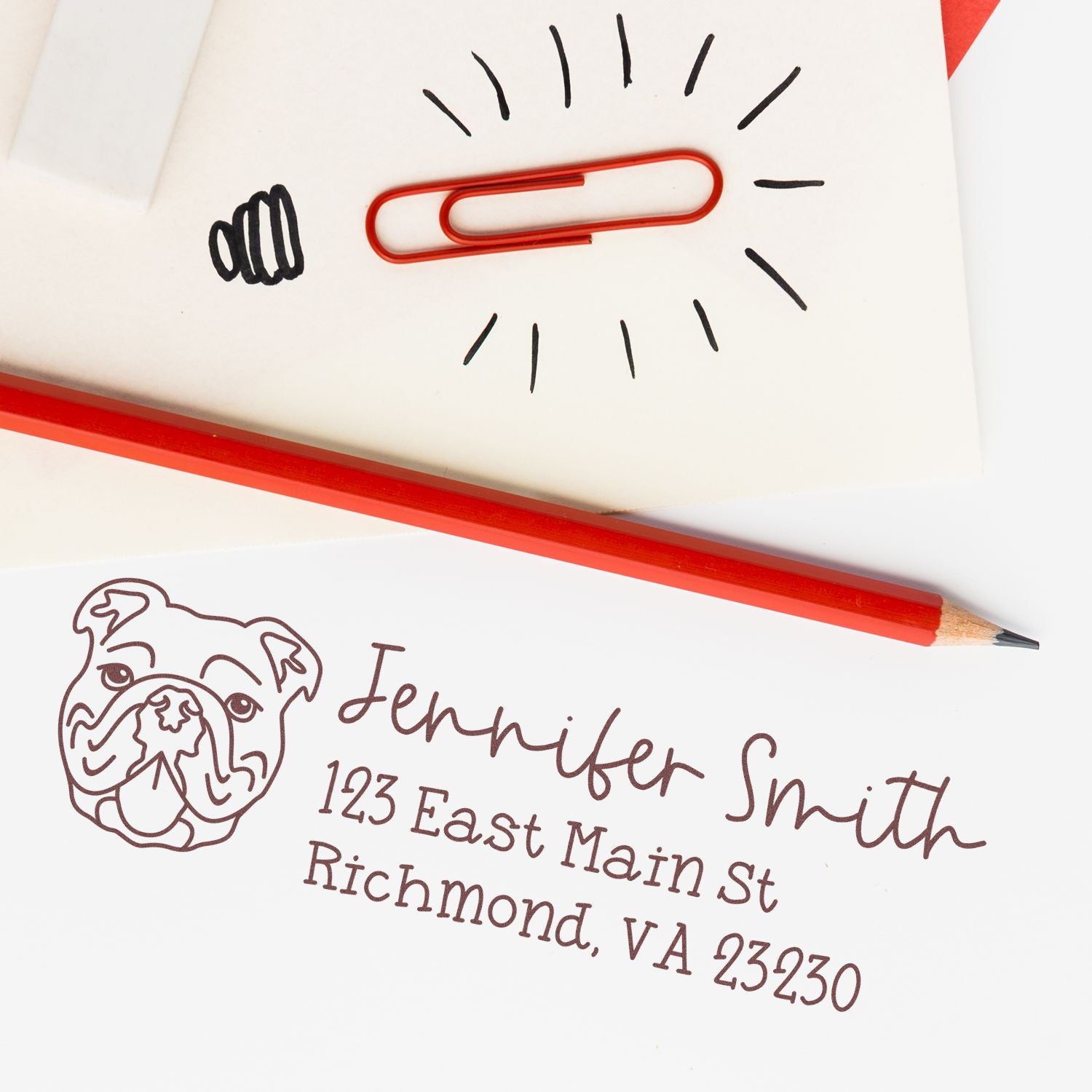 Personalized address rubber stamp with bulldog logo, showing name and Richmond, VA address on white stationery.