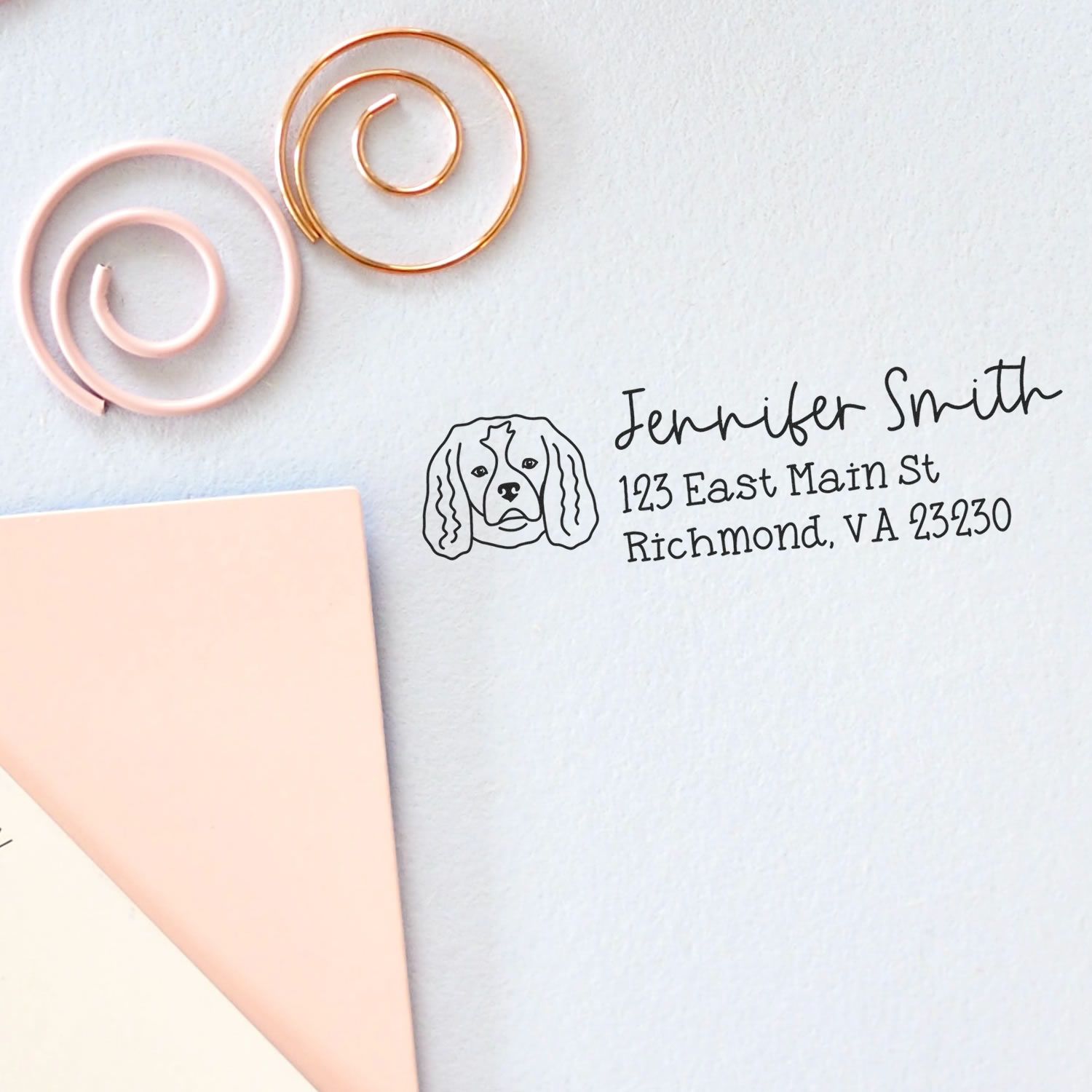 Personalized return address rubber stamp with dog illustration for envelopes, featuring name and address on stationery.