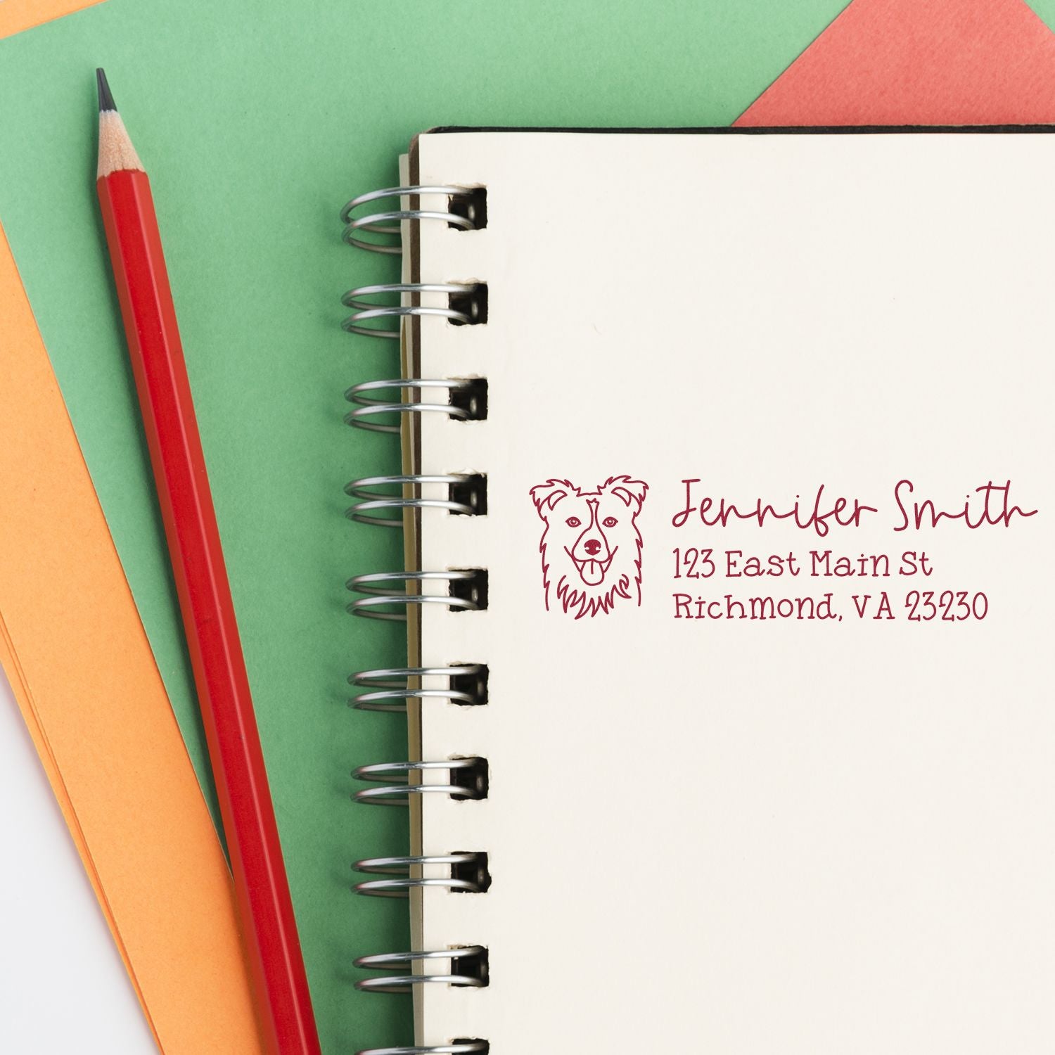 Custom return address rubber stamp with dog logo, used to personalize stationery with name and mailing address.