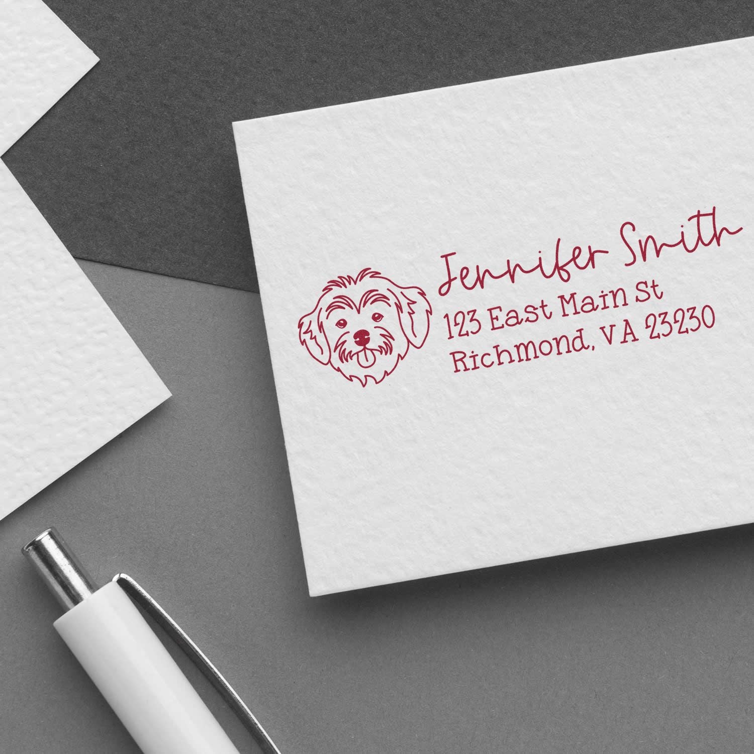 Custom rubber stamp on envelope with dog logo and personalized return address for Jennifer Smith, a pet-themed address stamp.