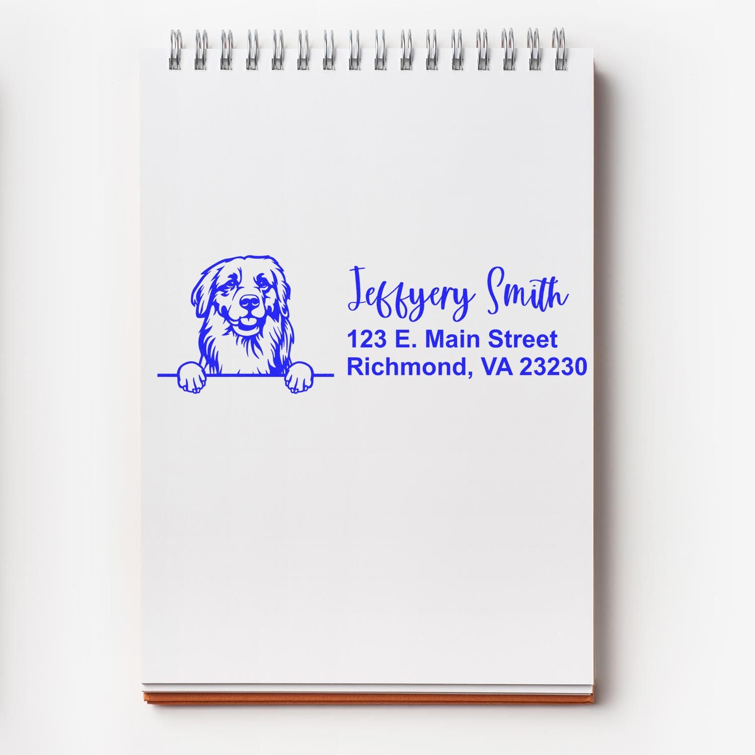 Custom rubber address stamp with dog logo and return address for Jeffrey Smith, Richmond, VA, on a notebook page.