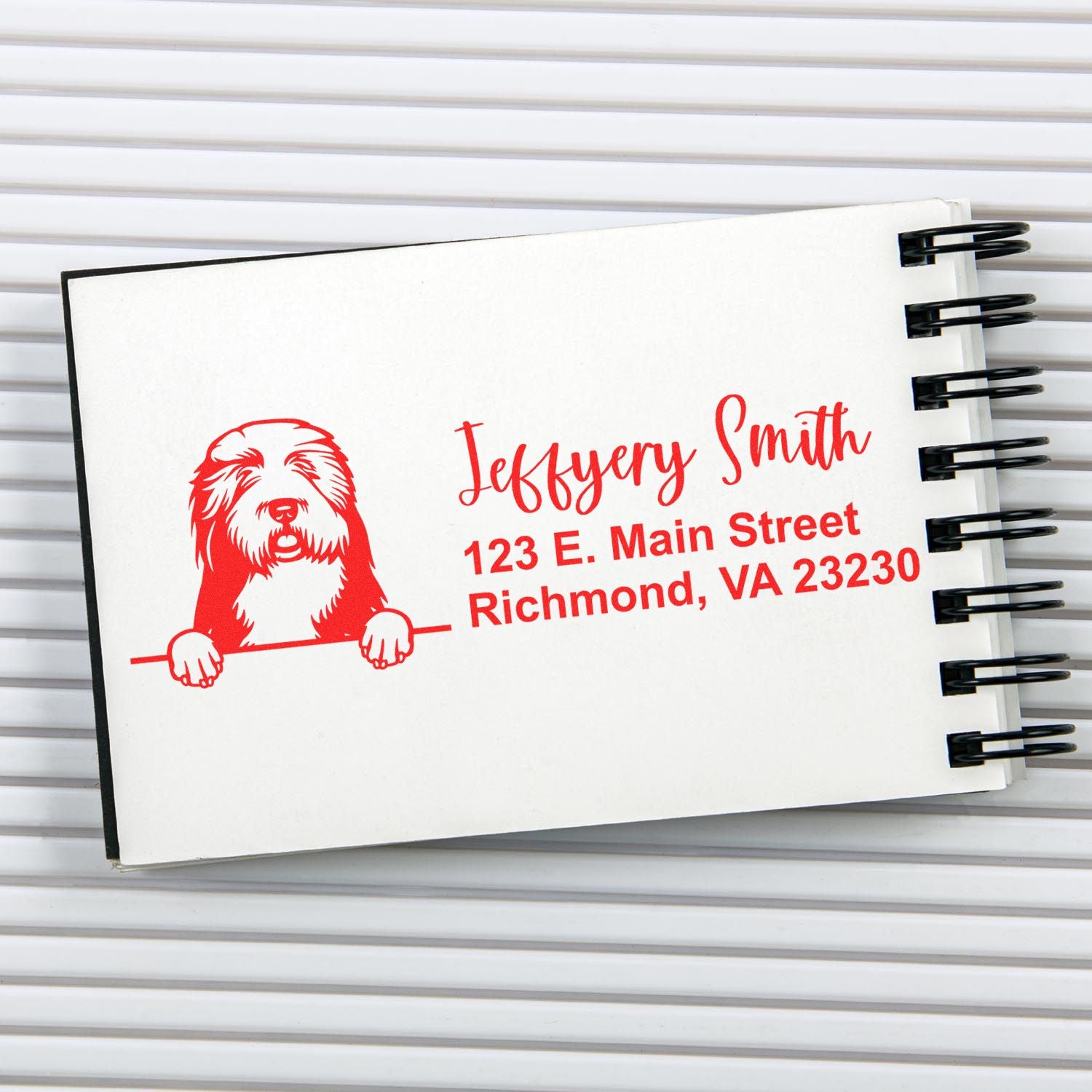 Custom dog address rubber stamp with name and Richmond, VA address printed on a spiral notebook