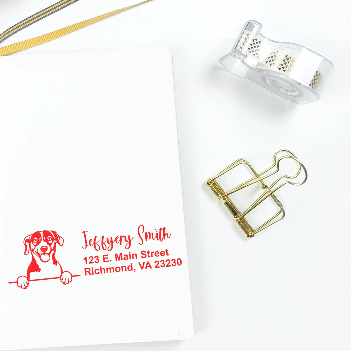 Custom return address rubber stamp with dog logo on stationery, ideal for personalized business mailings.