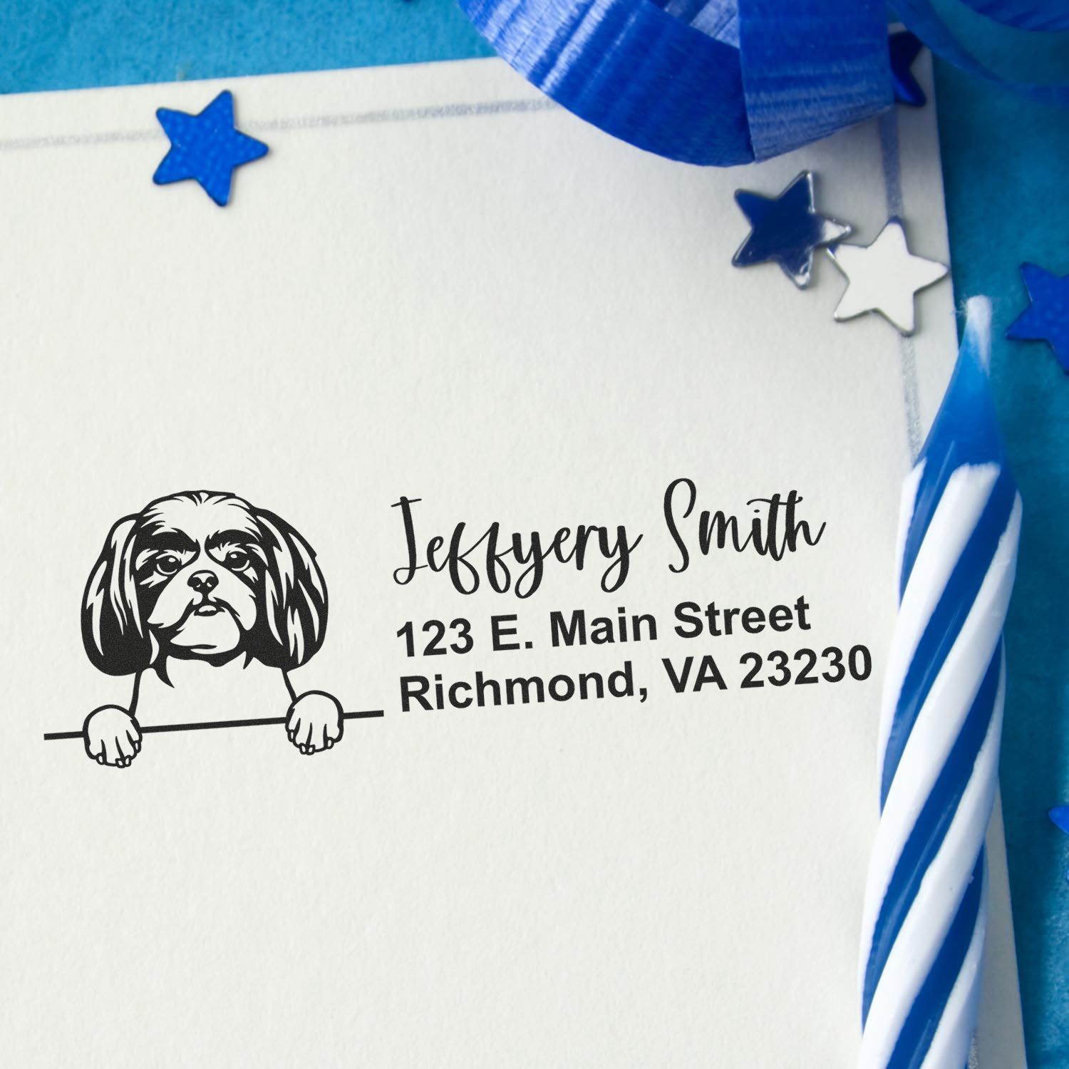 Custom dog return address rubber stamp with name and address on an envelope, decorated with blue star accents.