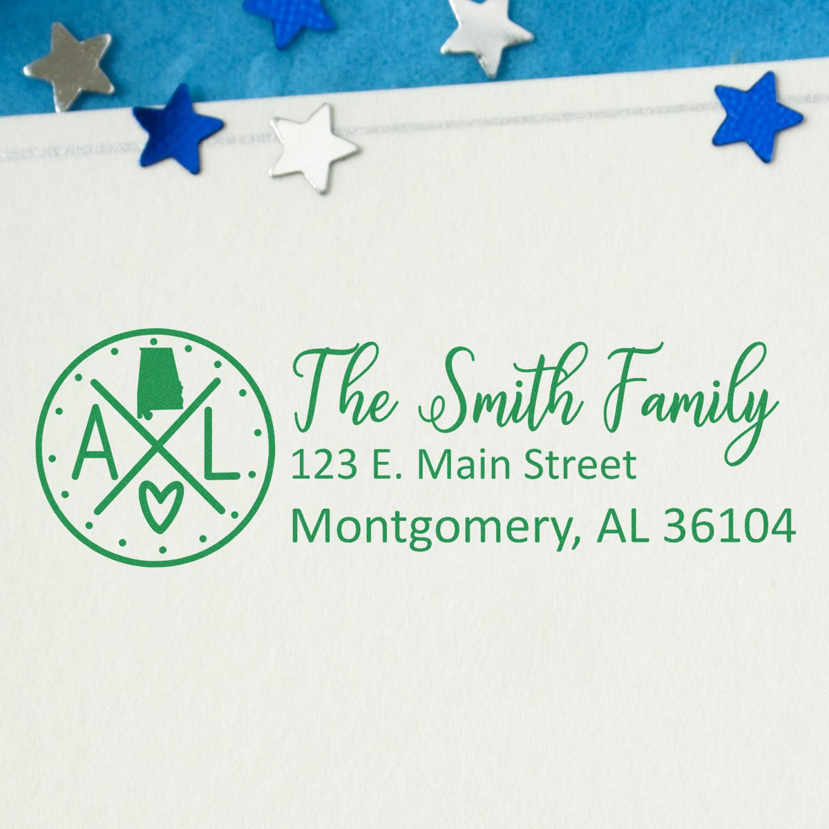 Custom family return address rubber stamp with monogram, name, and Montgomery, AL address in green ink.