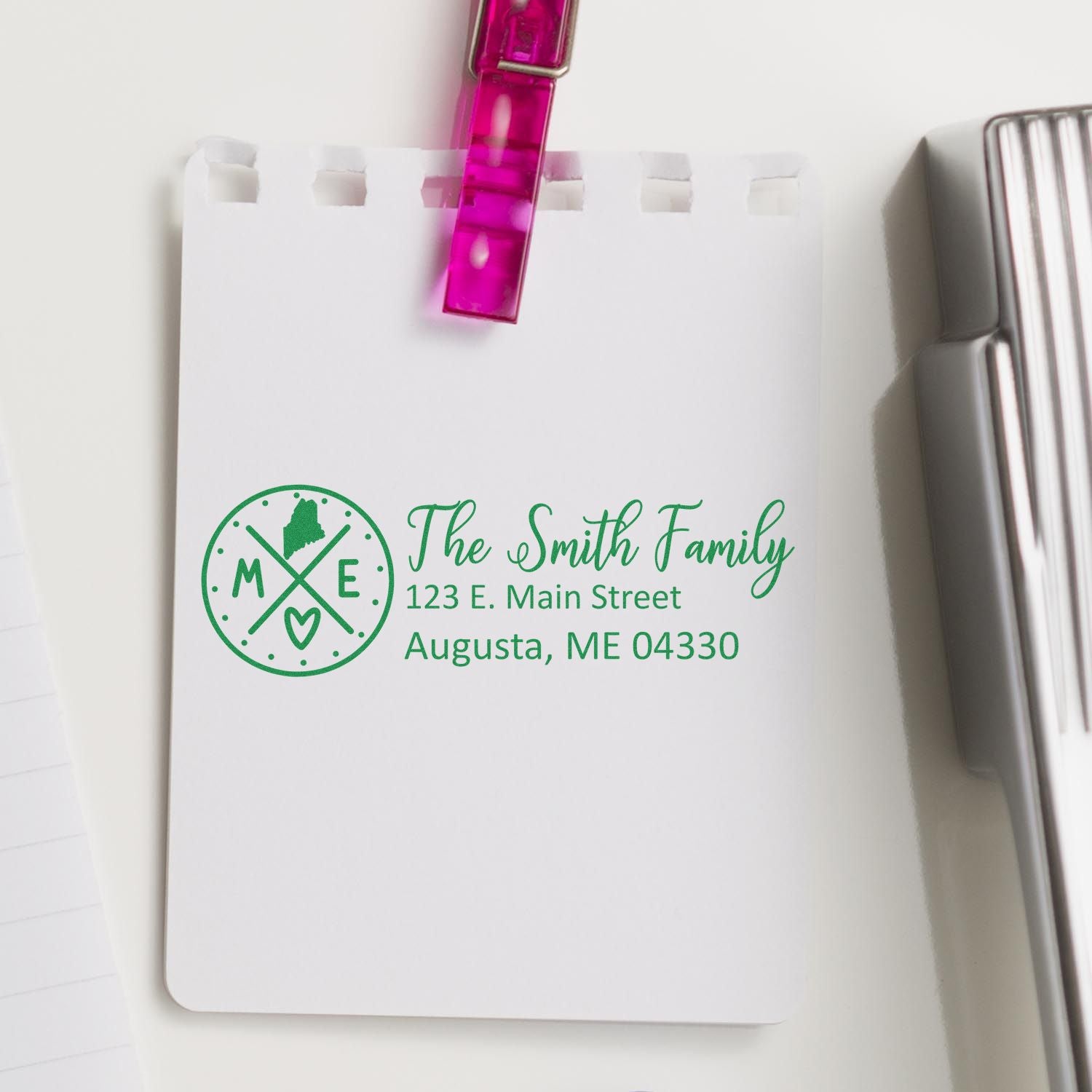 Custom family return address rubber stamp on notepad, featuring The Smith Family, Augusta, ME 04330.