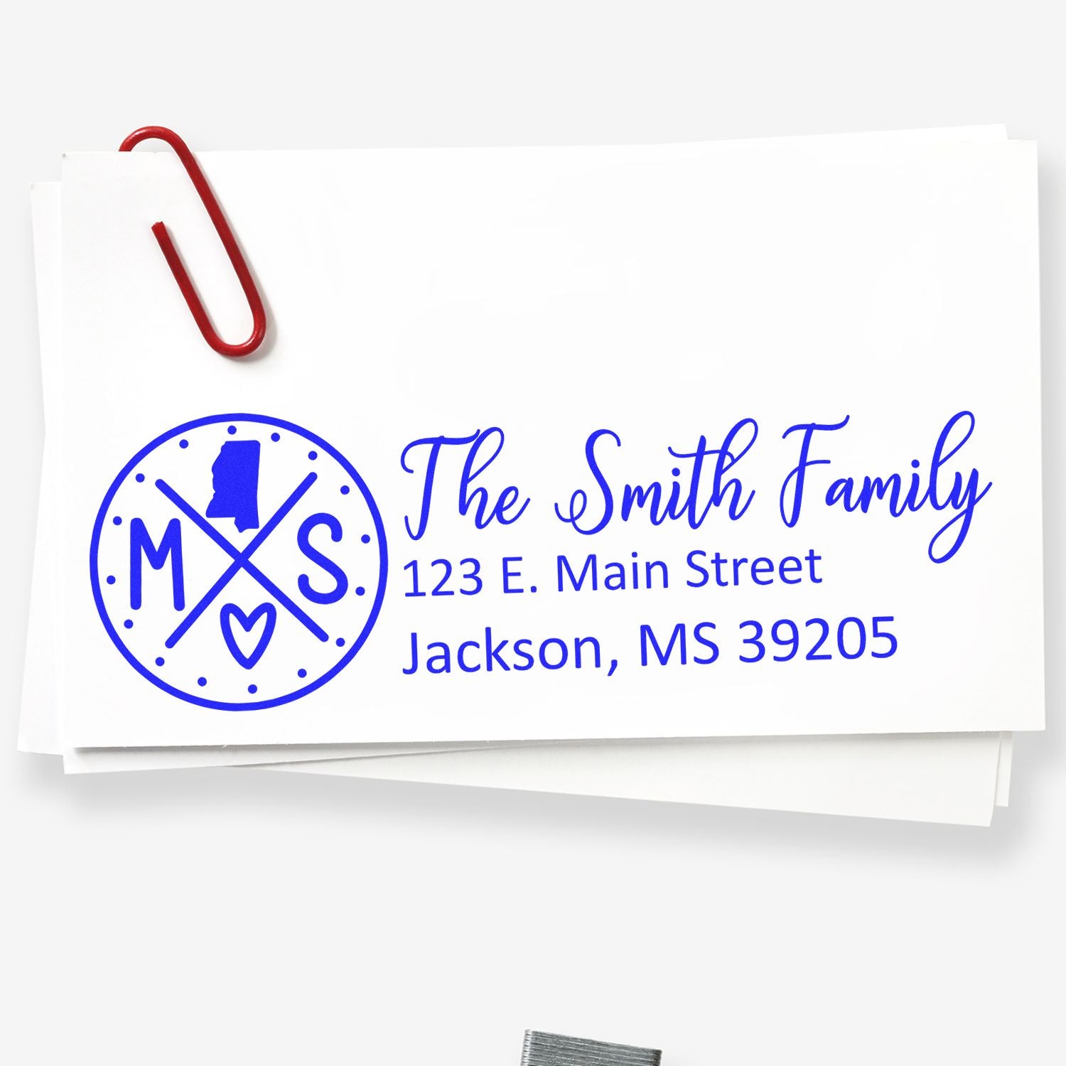 Custom family return address rubber stamp with monogram, name, and Jackson, MS address on paper.