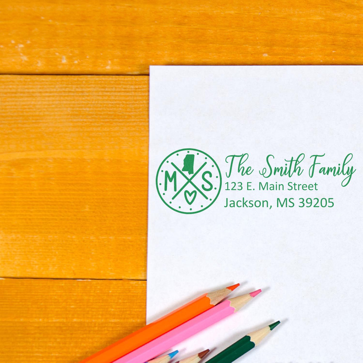 Custom family return address rubber stamp with monogram and address on paper, ideal for envelopes, invitations, and mailings.