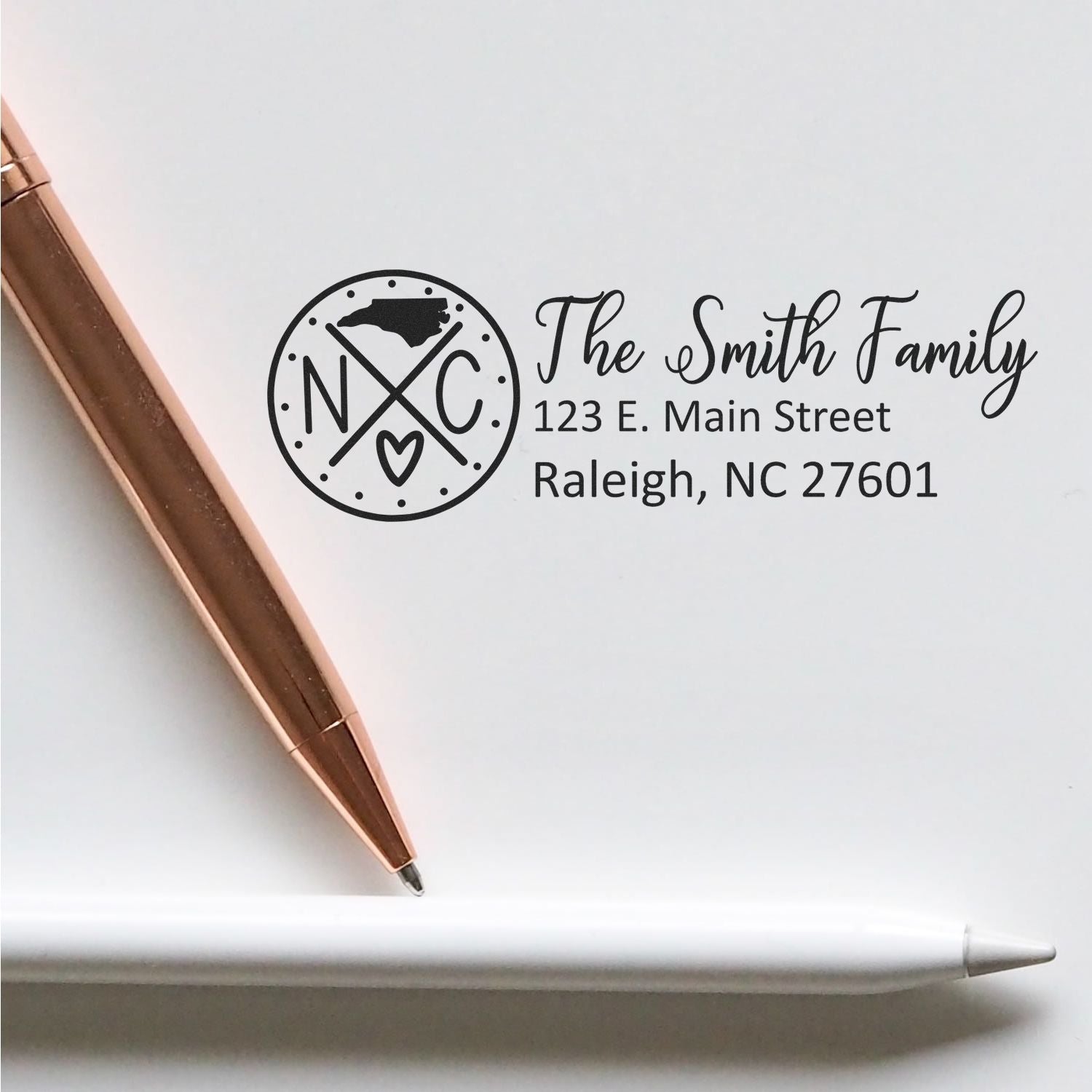 Personalized return address rubber stamp for The Smith Family, Raleigh, NC 27601, with North Carolina monogram.