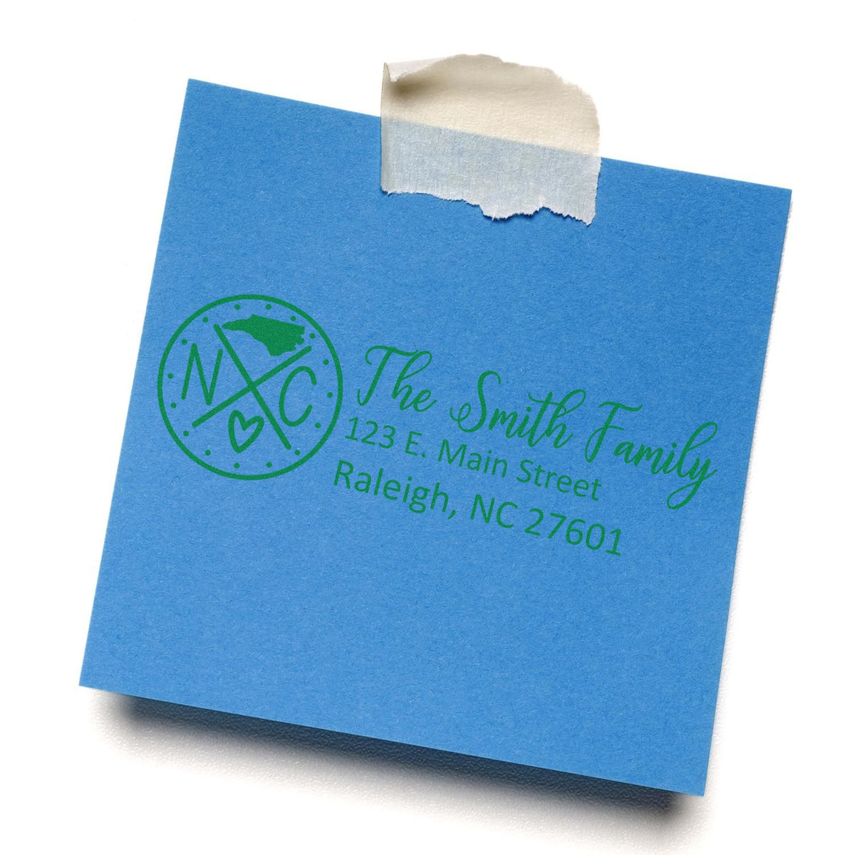 Personalized return address rubber stamp on blue envelope with family name, monogram logo, and Raleigh, NC address.