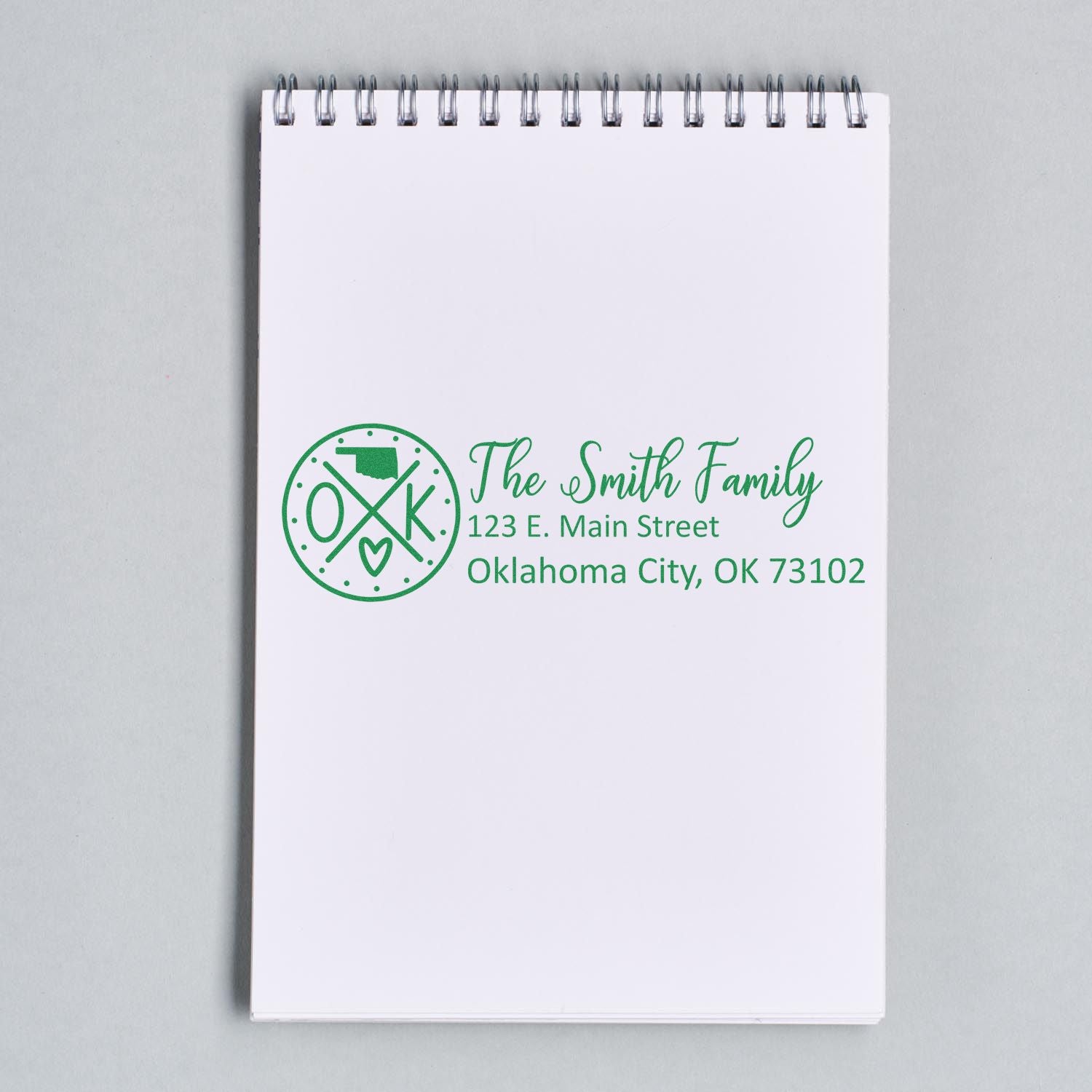 Personalized return address rubber stamp for The Smith Family with Oklahoma City, OK address on a notepad.