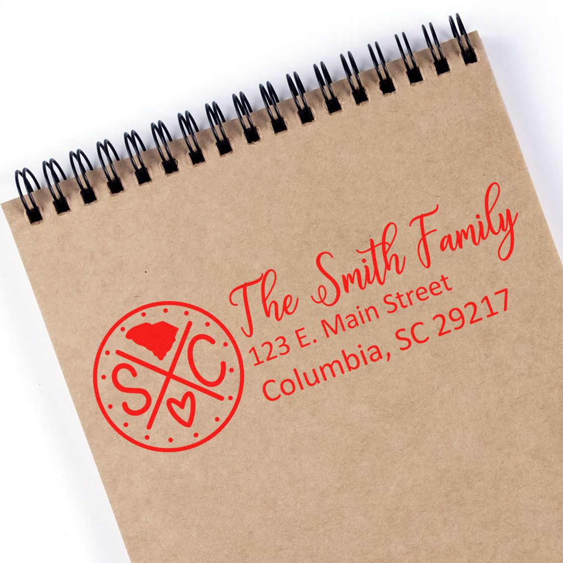 Custom return address stamp for The Smith Family with monogram logo and Columbia, SC address on a kraft notebook.