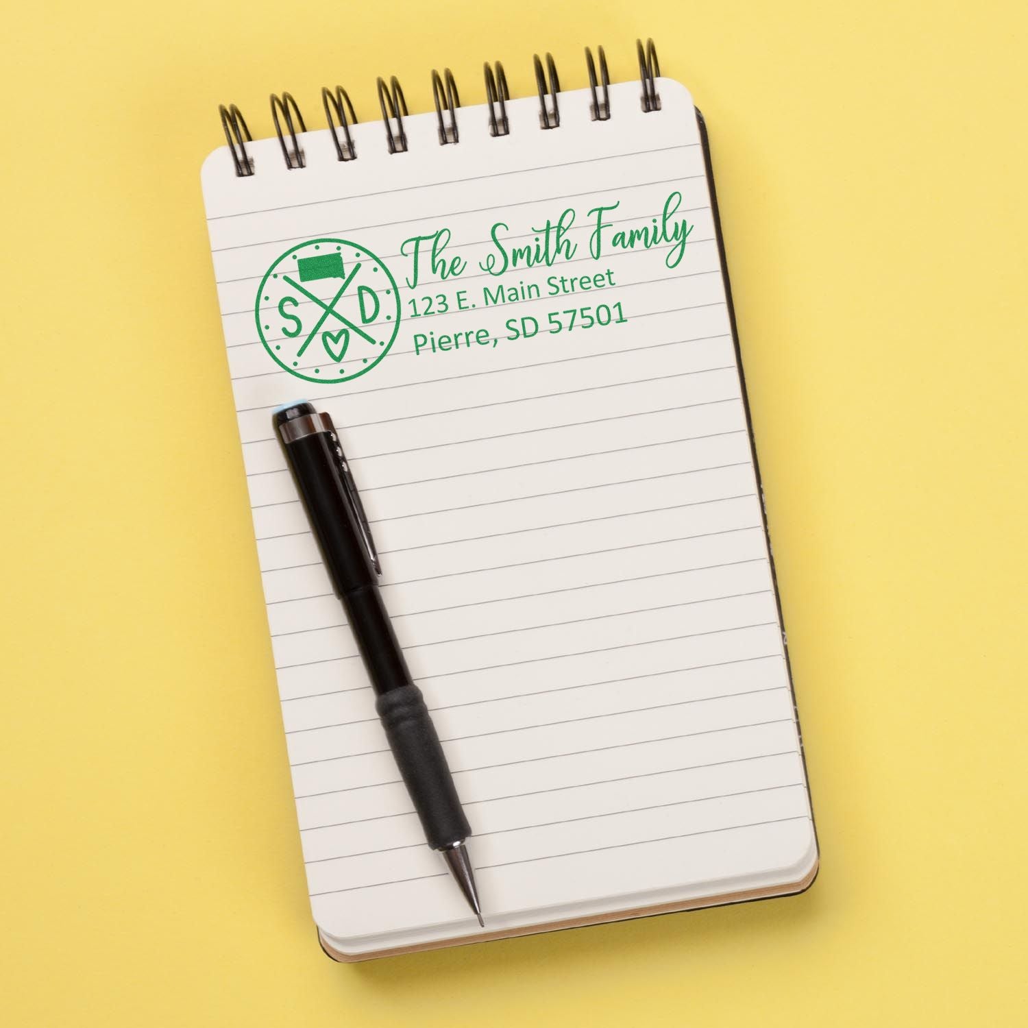 Custom address rubber stamp imprint on notepad, ideal for personalized mailing and home stationery.