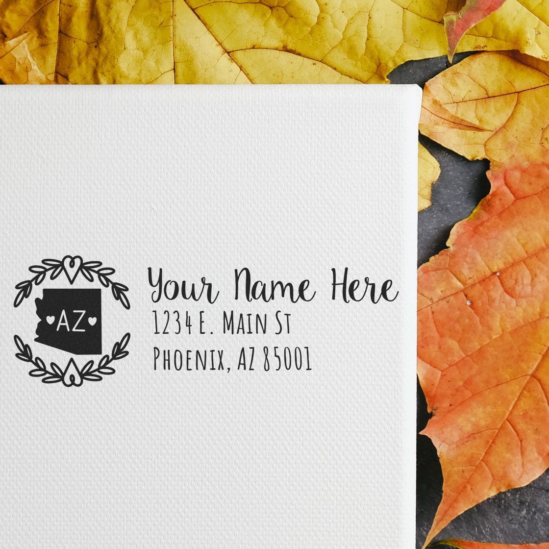 Custom Arizona return address rubber stamp with state monogram, floral wreath, and personalized name and mailing address.
