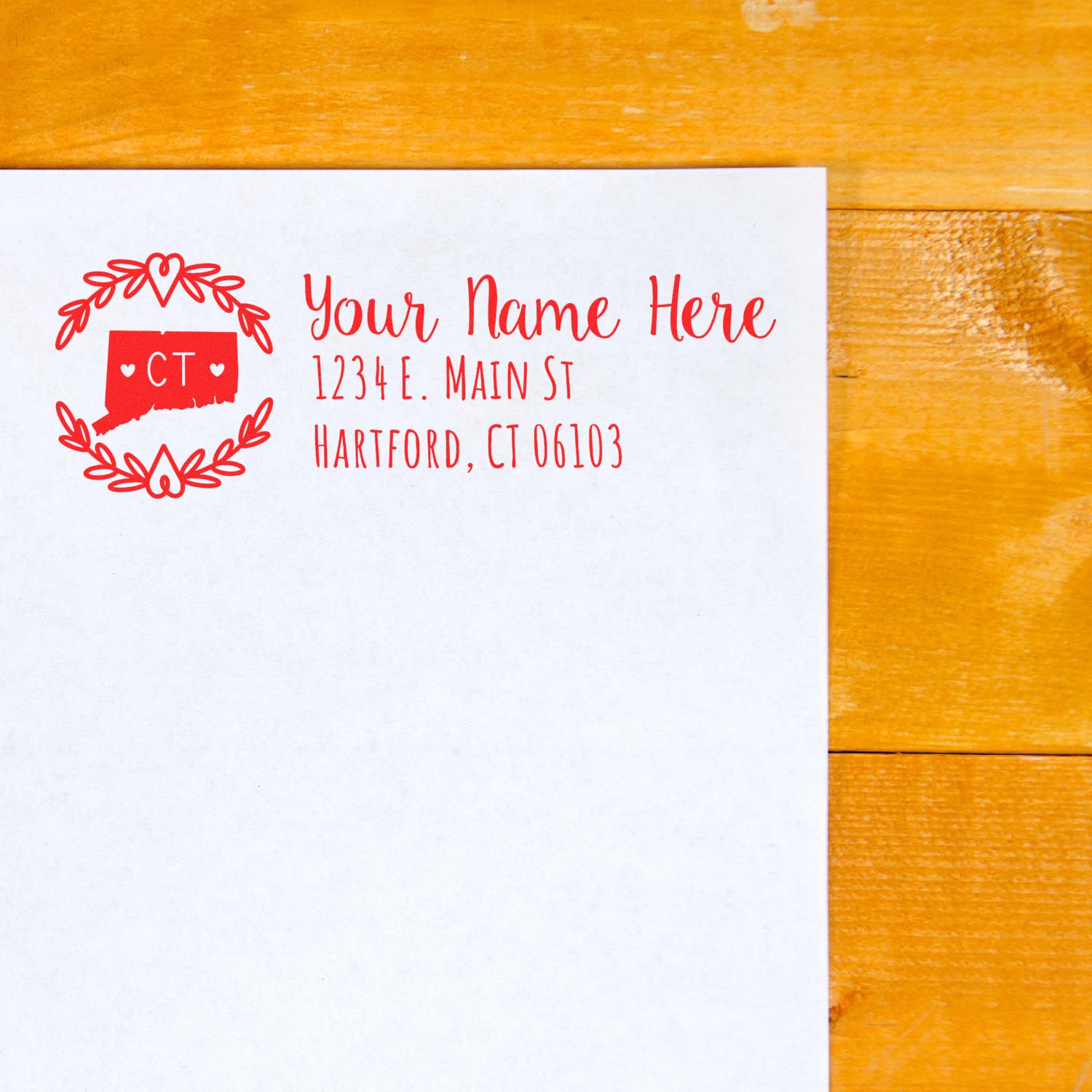 Custom return address rubber stamp in red with Connecticut design on white envelope for Hartford, CT mailing.