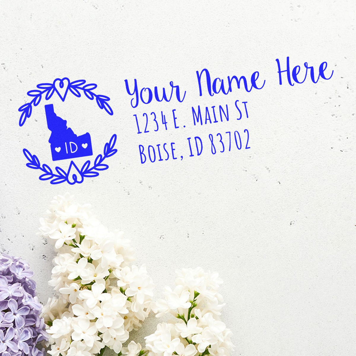 Custom Idaho return address rubber stamp with floral wreath, state outline, and personalized name and address.