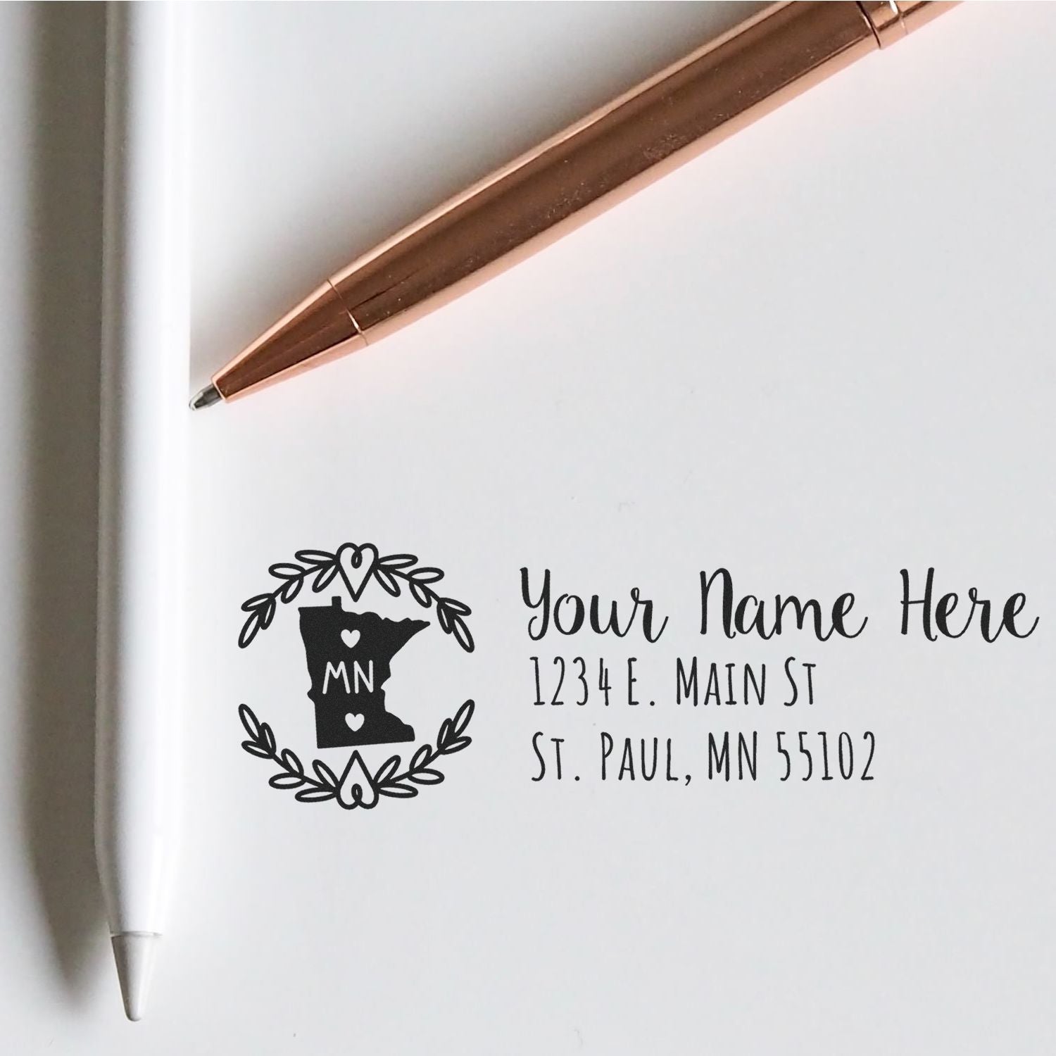 Custom return address rubber stamp with Minnesota state design and personalized name and address imprint for envelopes.