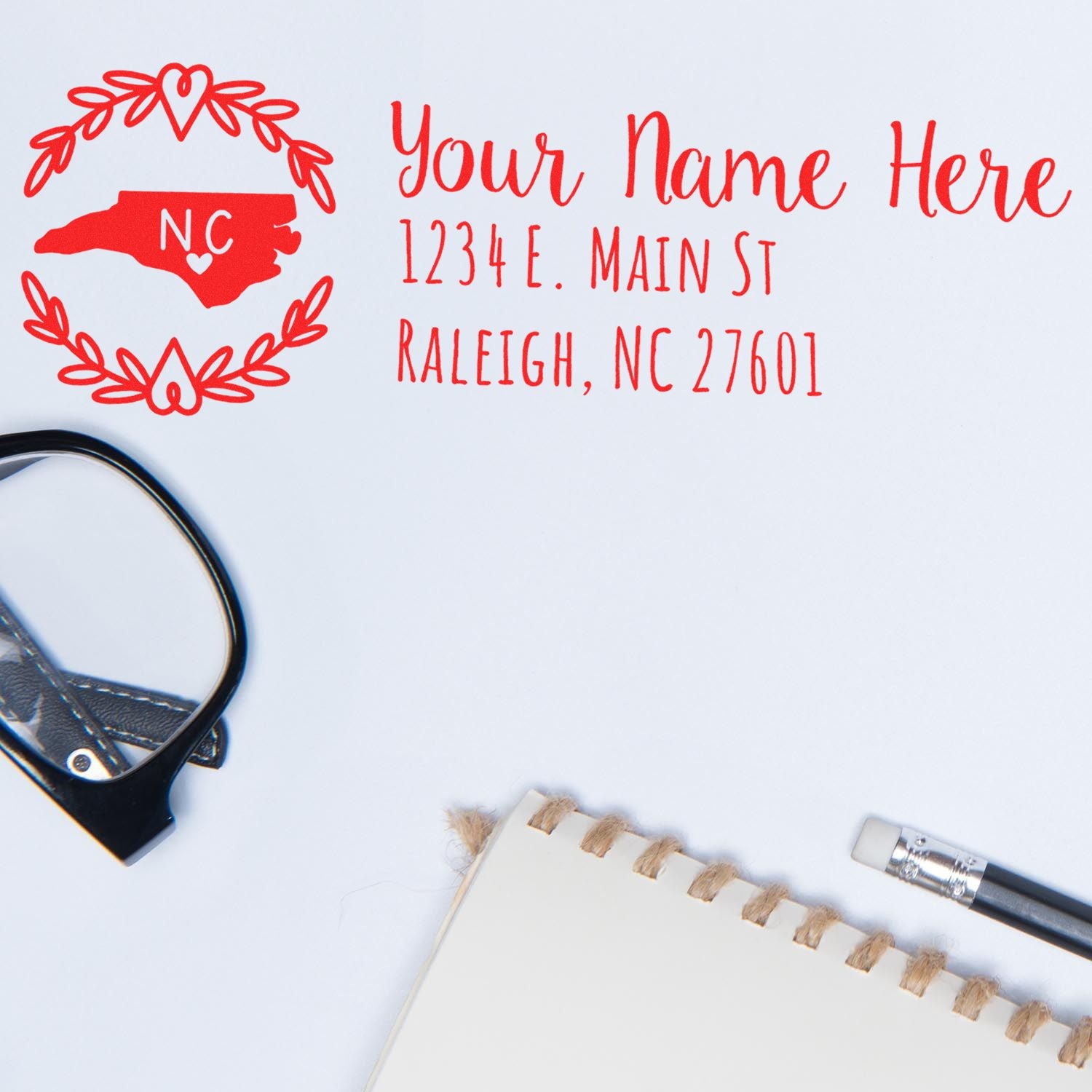 Custom North Carolina return address rubber stamp with wreath design and personalized name, city, and ZIP code.