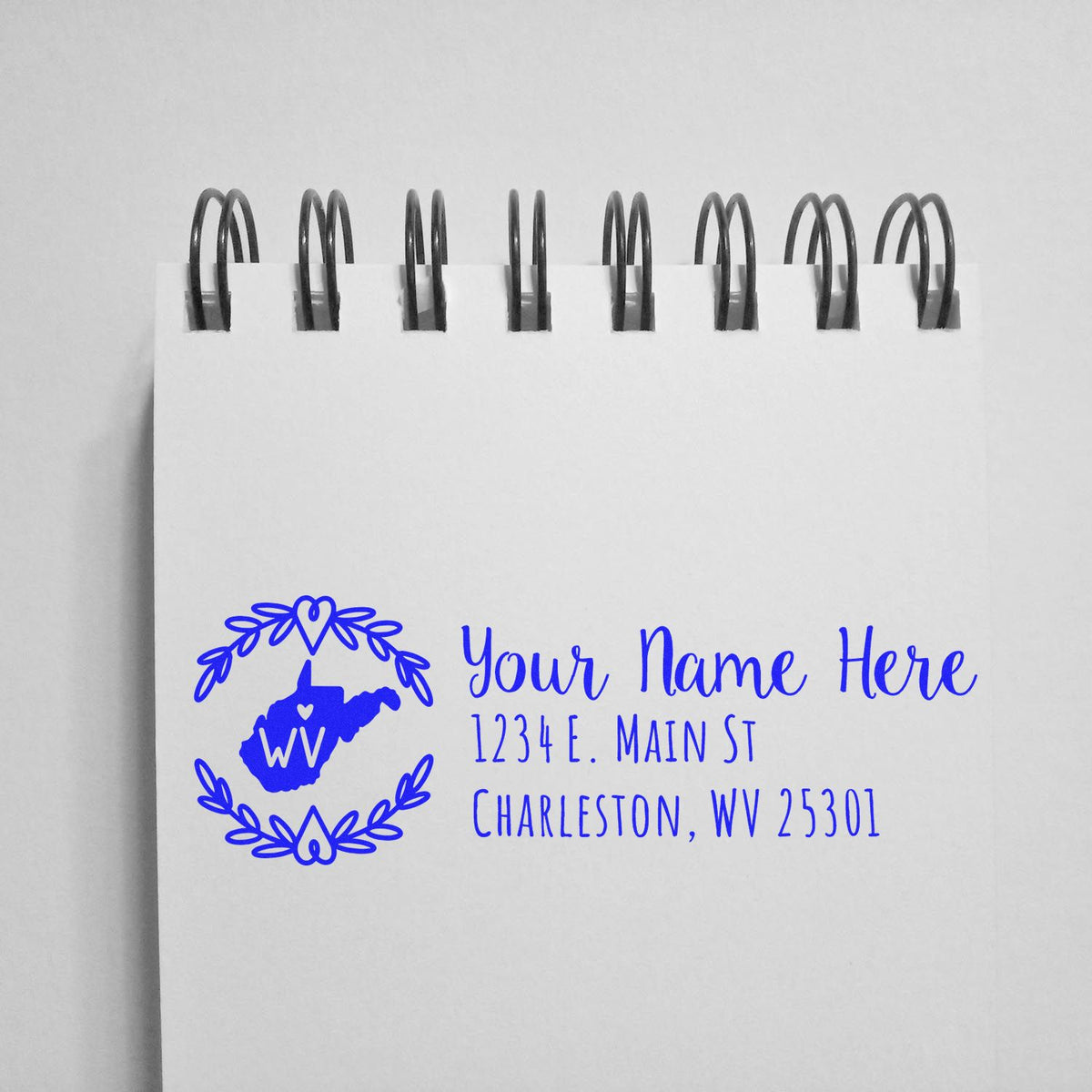 Custom West Virginia return address rubber stamp with floral wreath, name, and address for personalized mailing.