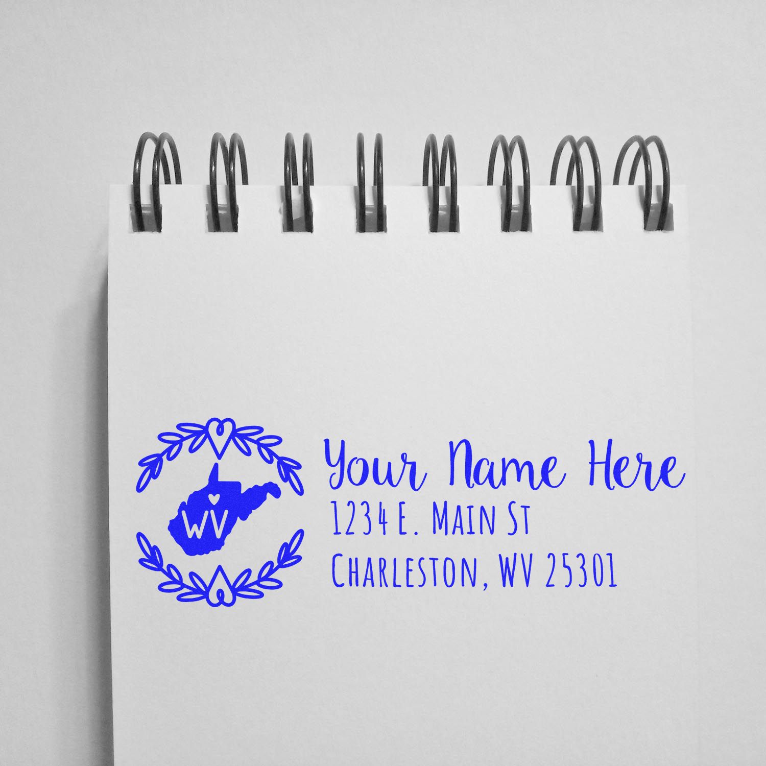Custom return address rubber stamp with West Virginia state design, name, and mailing address for personalized envelopes.