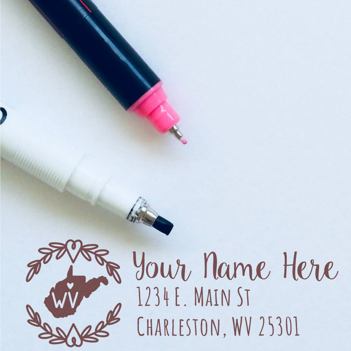 Custom self-inking West Virginia address rubber stamp design with name, street, and Charleston, WV 25301.