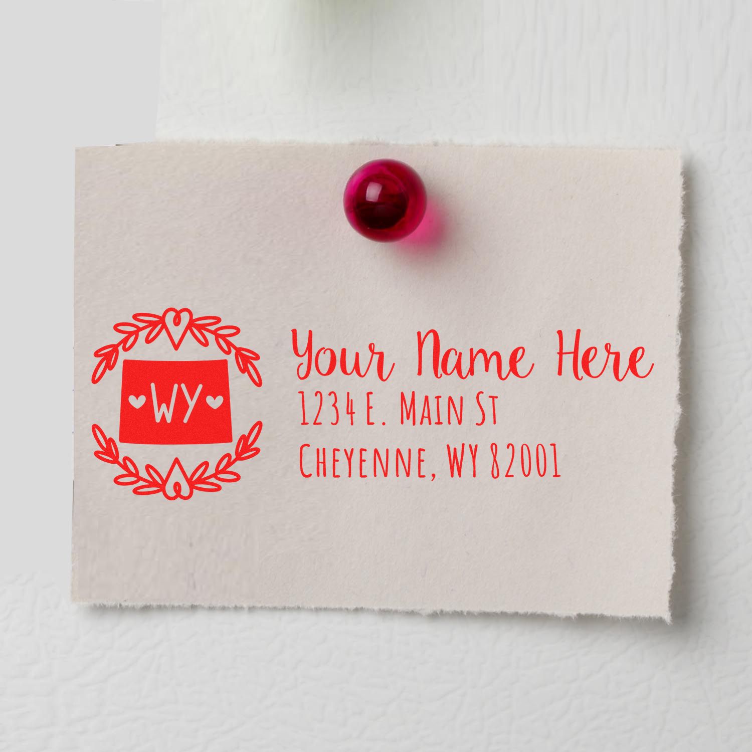Personalized return address rubber stamp with monogram wreath design and Cheyenne, WY mailing address sample.