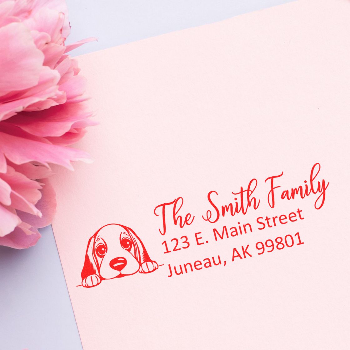 Custom return address rubber stamp with dog illustration for The Smith Family, Juneau AK, for envelopes and mailing labels.