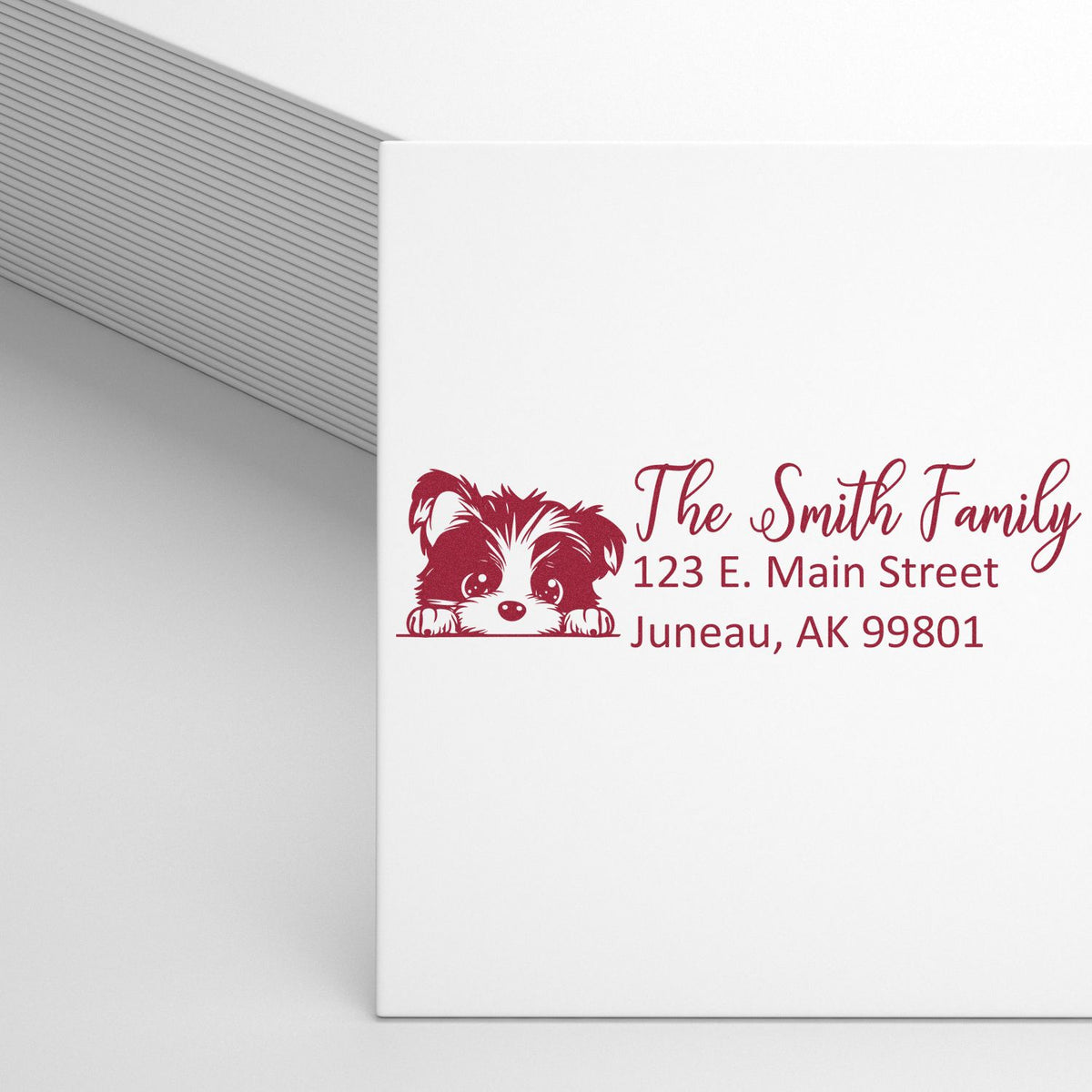 Custom rubber return address stamp with dog illustration for The Smith Family, Juneau, AK.
