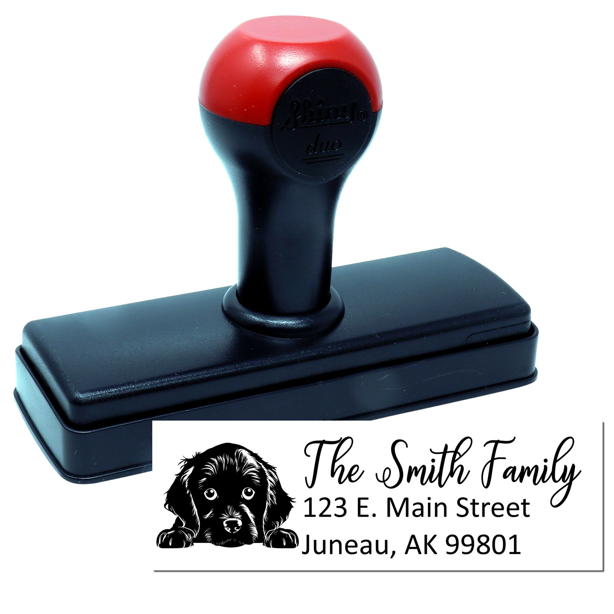 Self-inking custom rubber stamp with dog graphic and personalized family return address imprint.