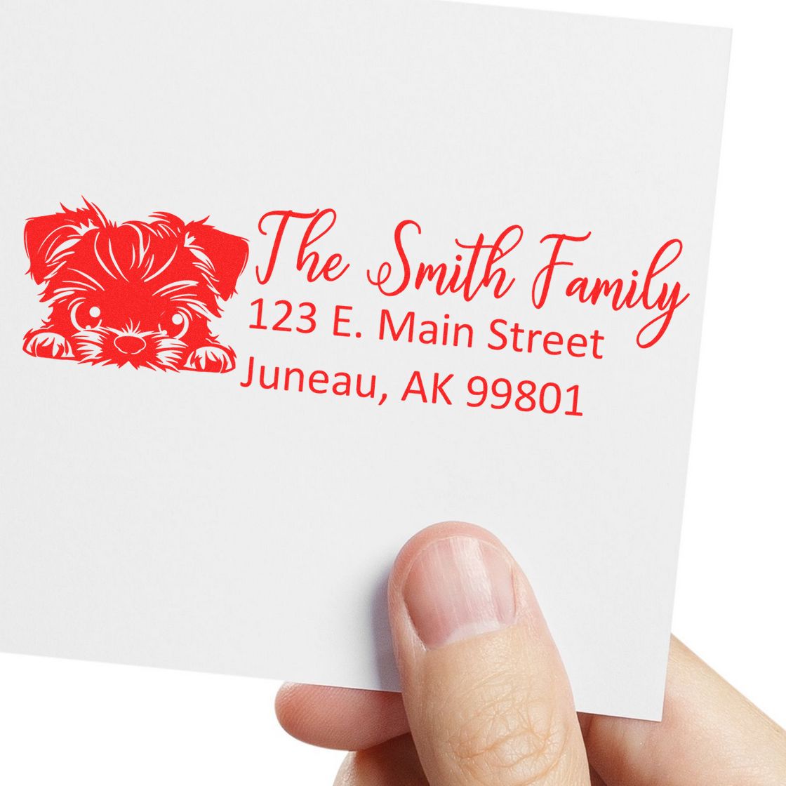 Personalized rubber address stamp with dog graphic and The Smith Family return address on white paper