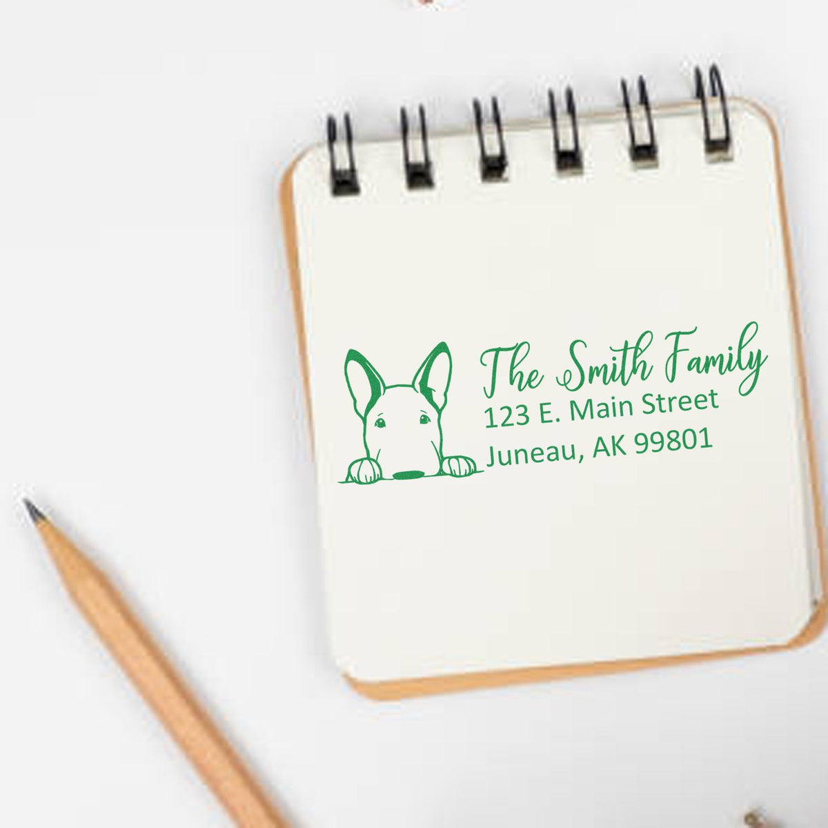 Custom return address rubber stamp for The Smith Family with dog graphic and Juneau, AK mailing address.