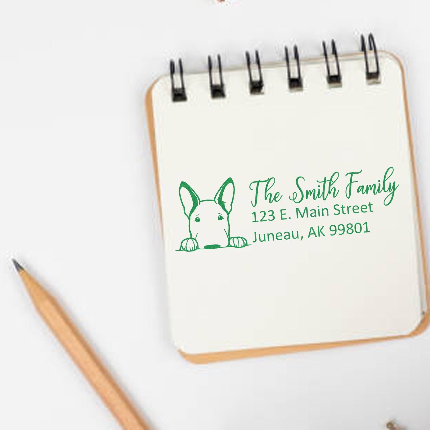 Personalized rubber address stamp with dog illustration and The Smith Family return address, Juneau, AK.