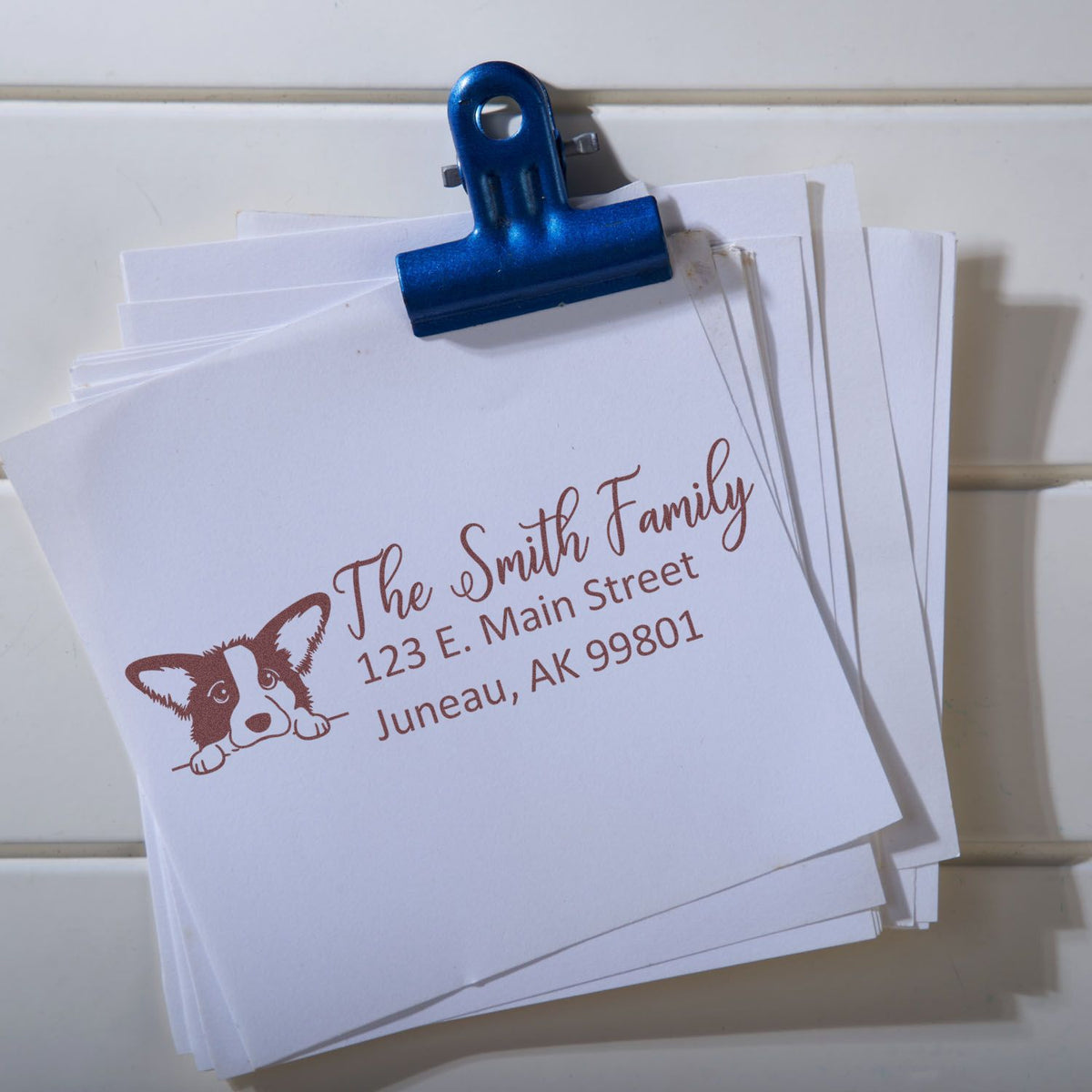 Custom address rubber stamp impression on stacked cards, featuring dog logo and The Smith Family return address.