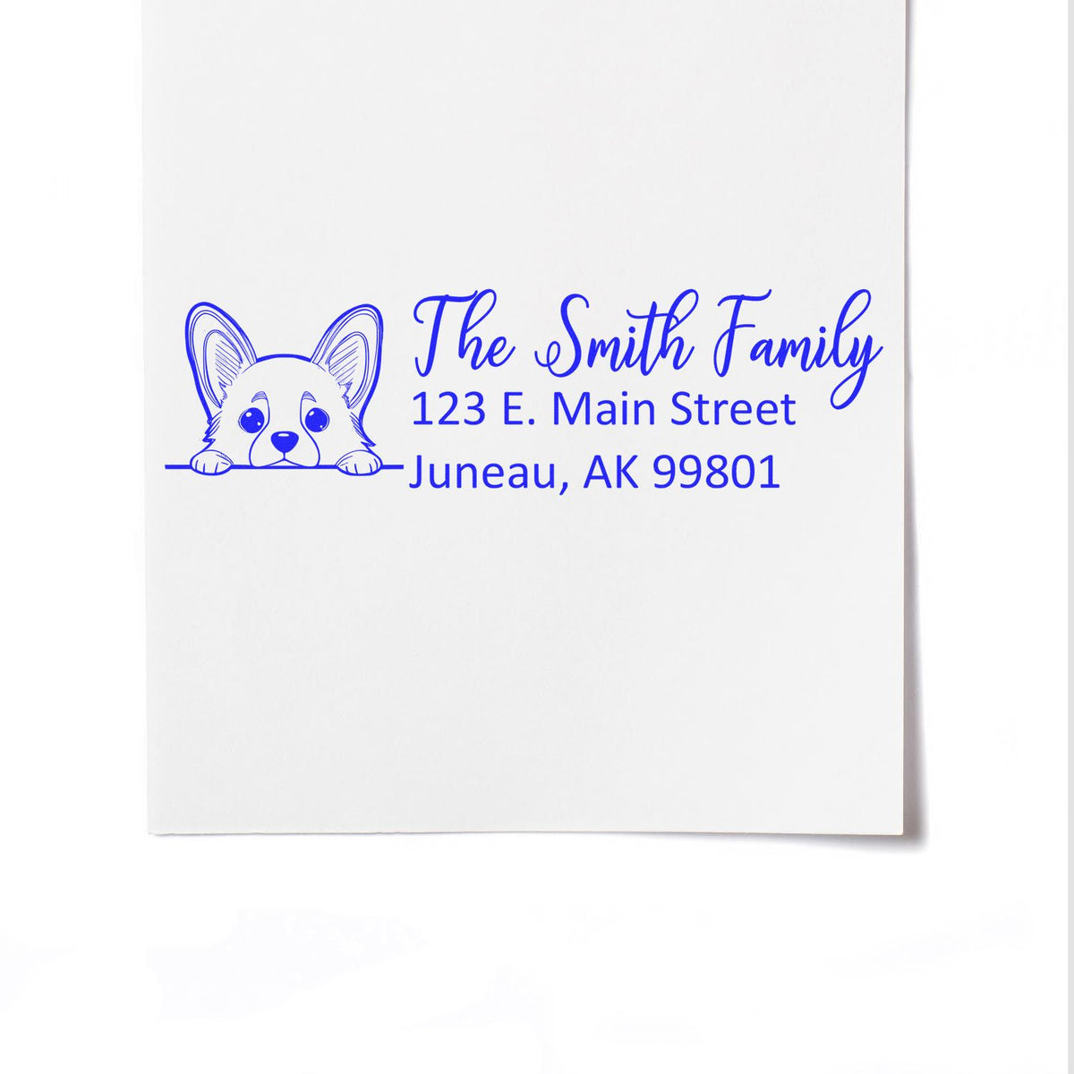 Custom rubber stamp return address with corgi dog and The Smith Family, 123 E. Main Street, Juneau, AK 99801.