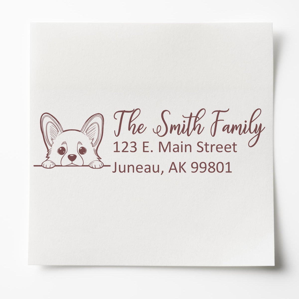 Personalized rubber address stamp with corgi illustration for The Smith Family, Juneau, AK 99801.