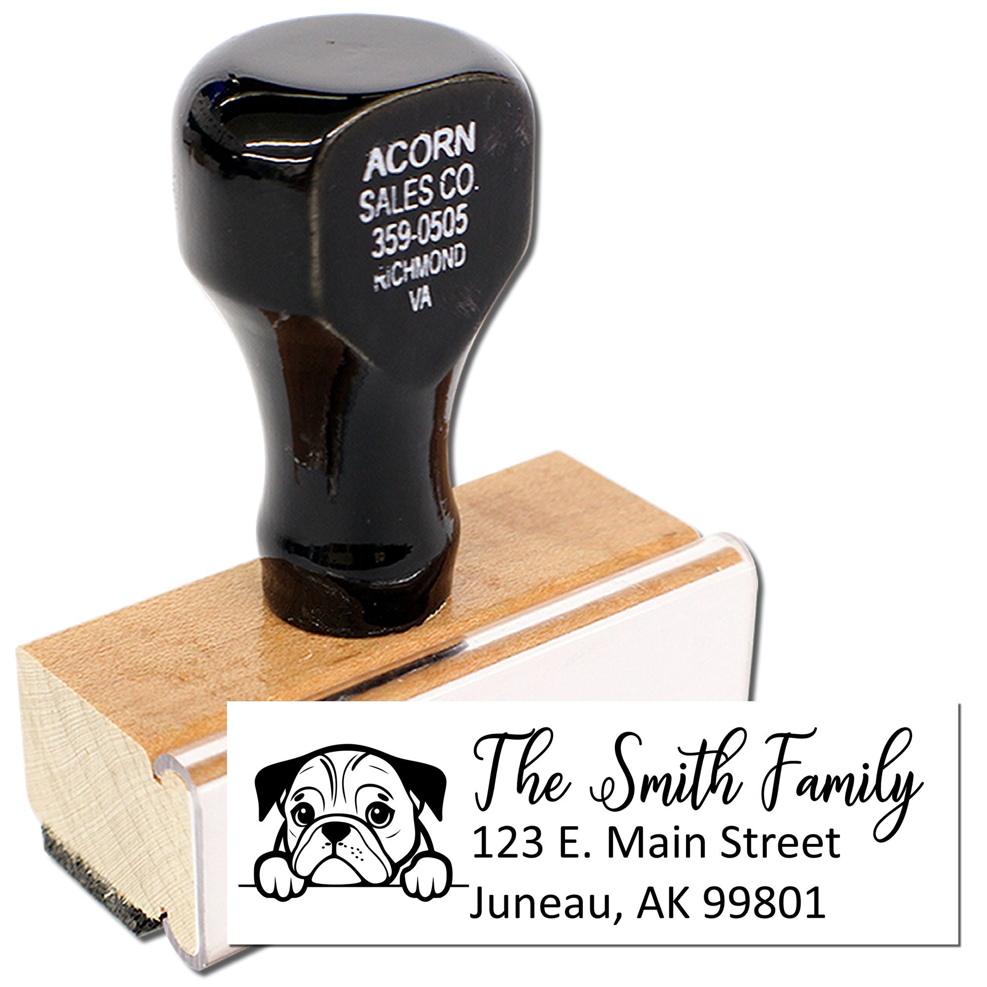 Custom return address rubber stamp with dog illustration, family name, and address on a wooden stamp block.
