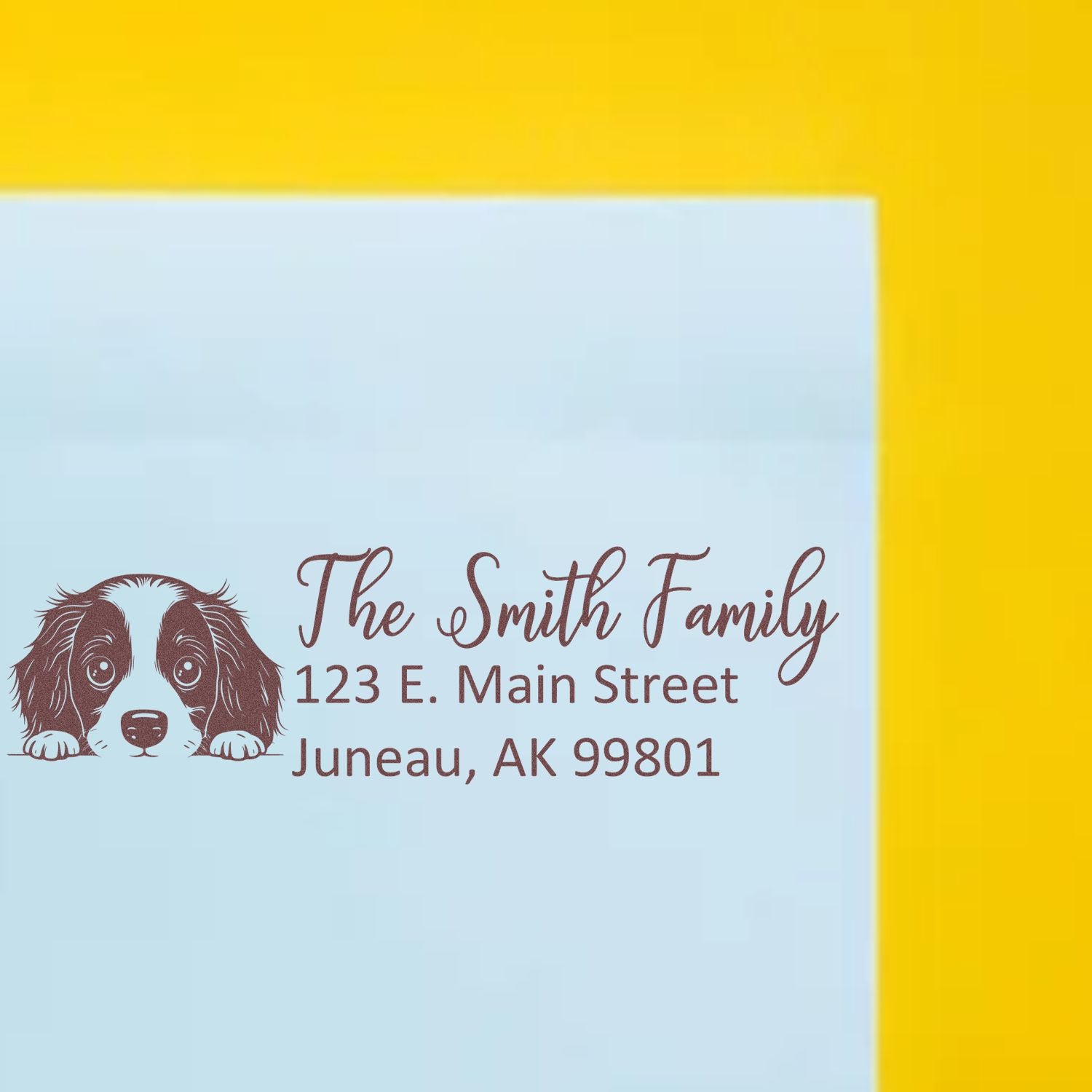 Custom rubber return address stamp with dog illustration for The Smith Family, Juneau, AK 99801.