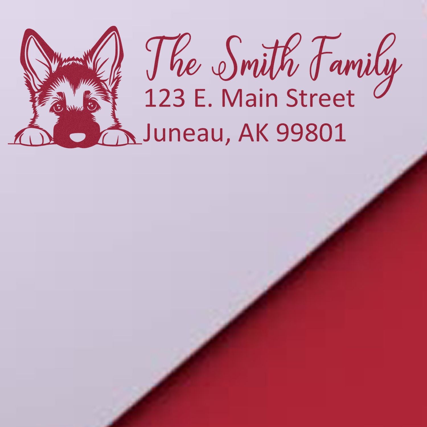 Custom return address rubber stamp with dog illustration for The Smith Family, 123 E. Main Street, Juneau, AK 99801.