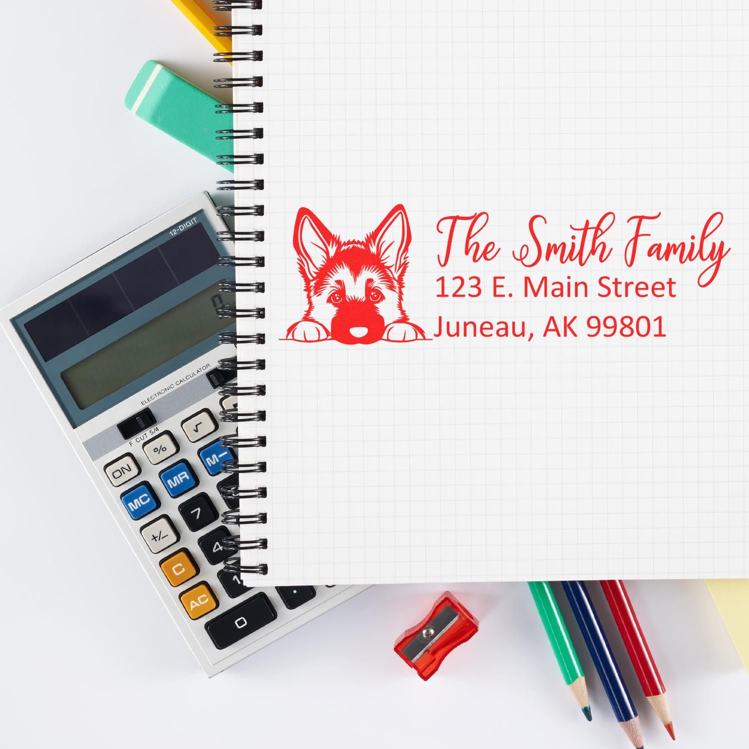 Personalized return address rubber stamp with dog logo on notebook, ideal for family mailing and stationery